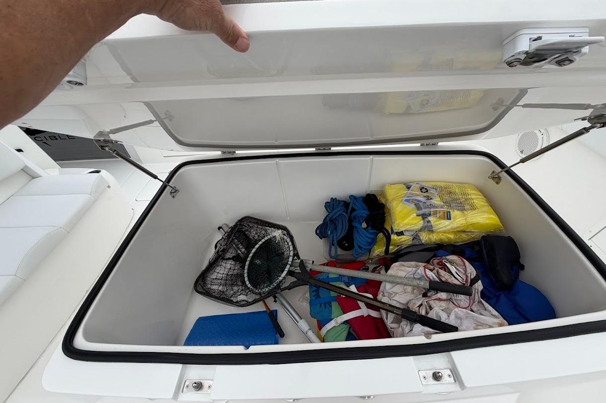 Storage compartment on 2019 Invincible 40 Catamaran with fishing gear and supplies.