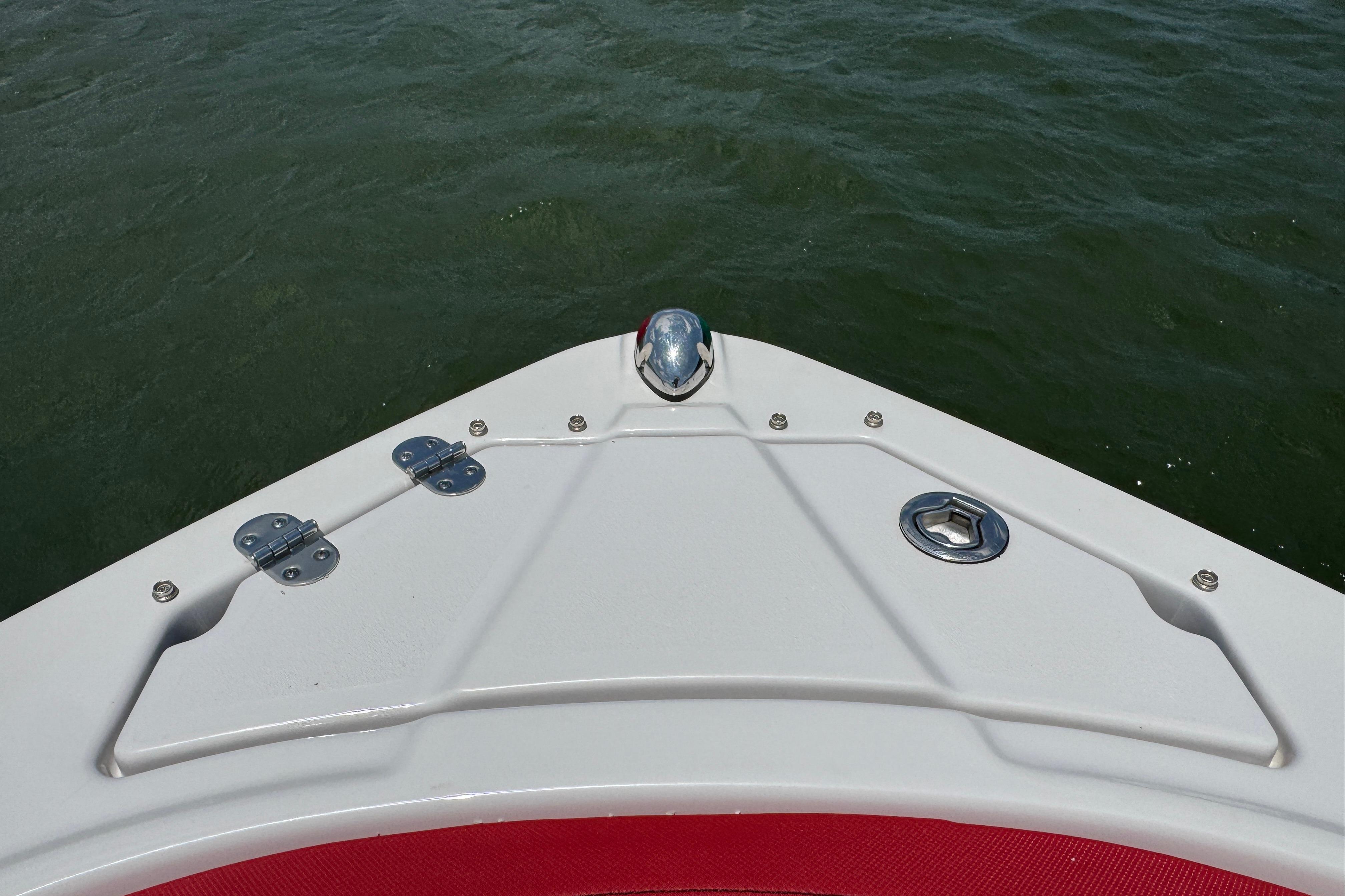 Bow of 2017 Glastron GT 225 boat on water, featuring sleek design and hardware.