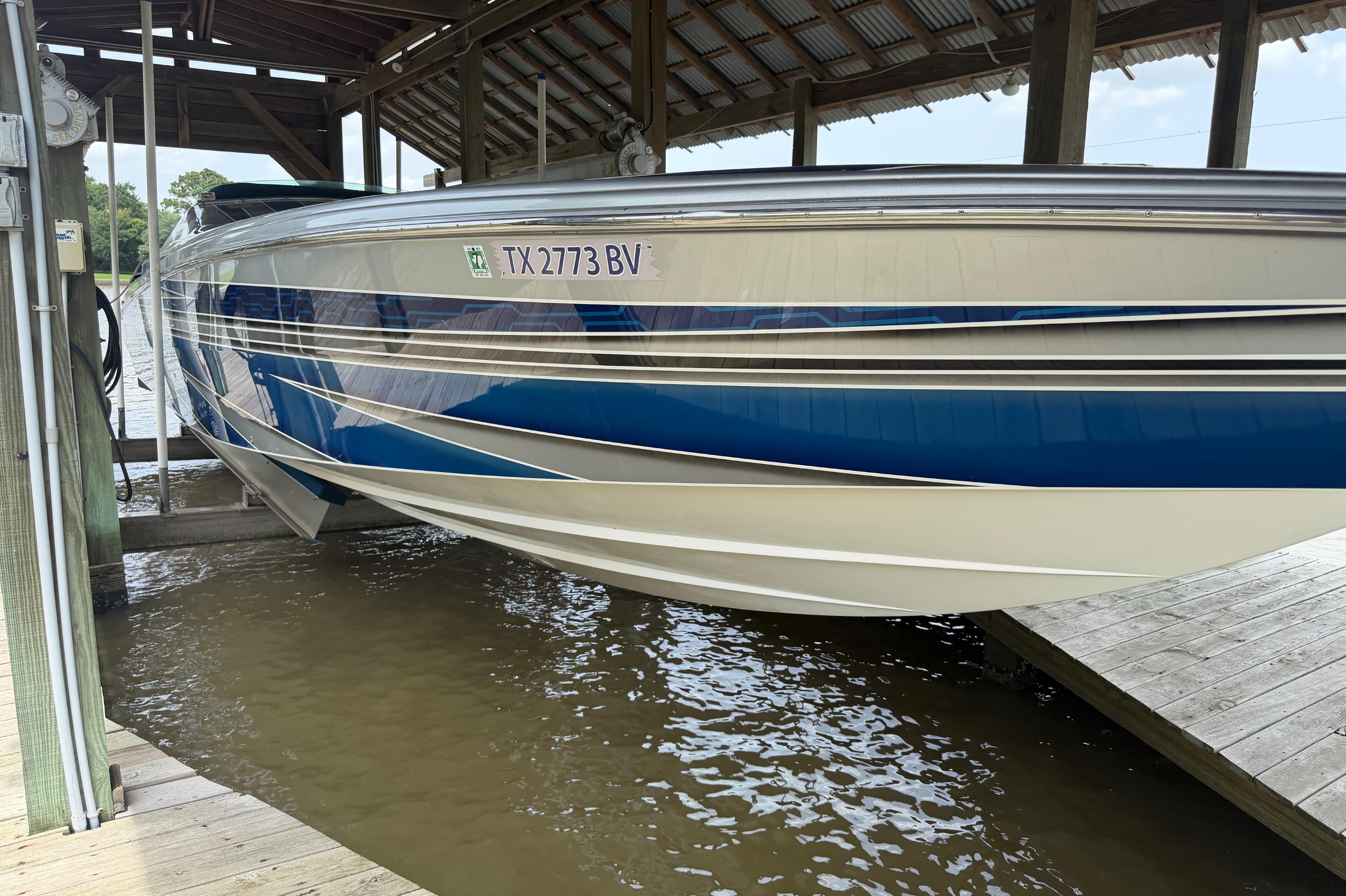 2013 Nor-Tech 477 SPX Vee Bottom boat docked, featuring sleek blue and white design.