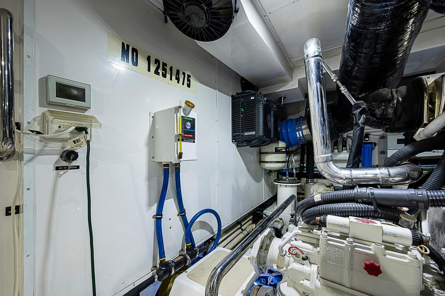 Engine room of 2014 Marlow 80 Explorer yacht with equipment and piping.
