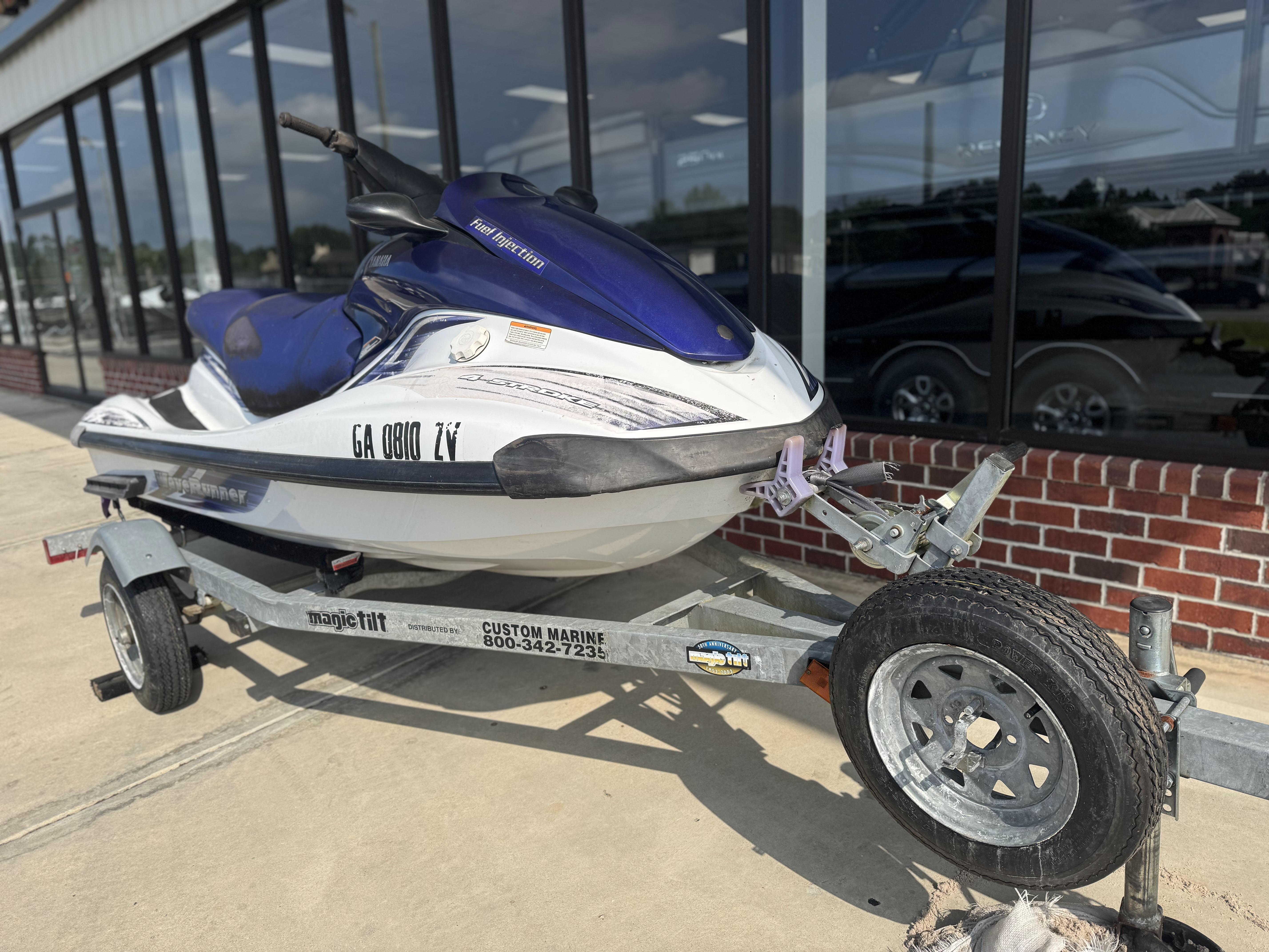 2003 Yamaha WaveRunner FX140 on trailer, parked outside a building.