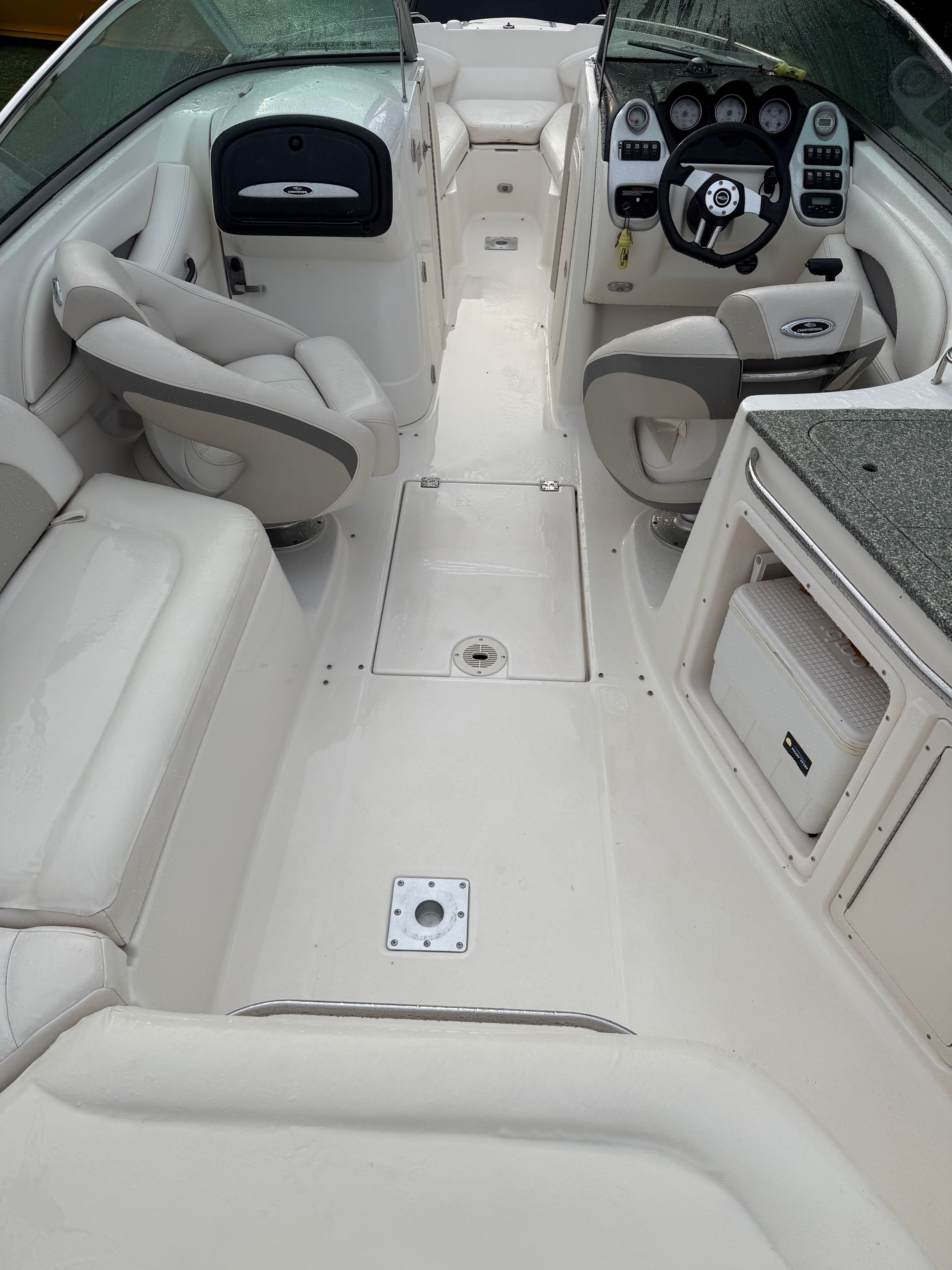 Interior of a 2007 Chaparral 256 SSX with white seating and a steering console.