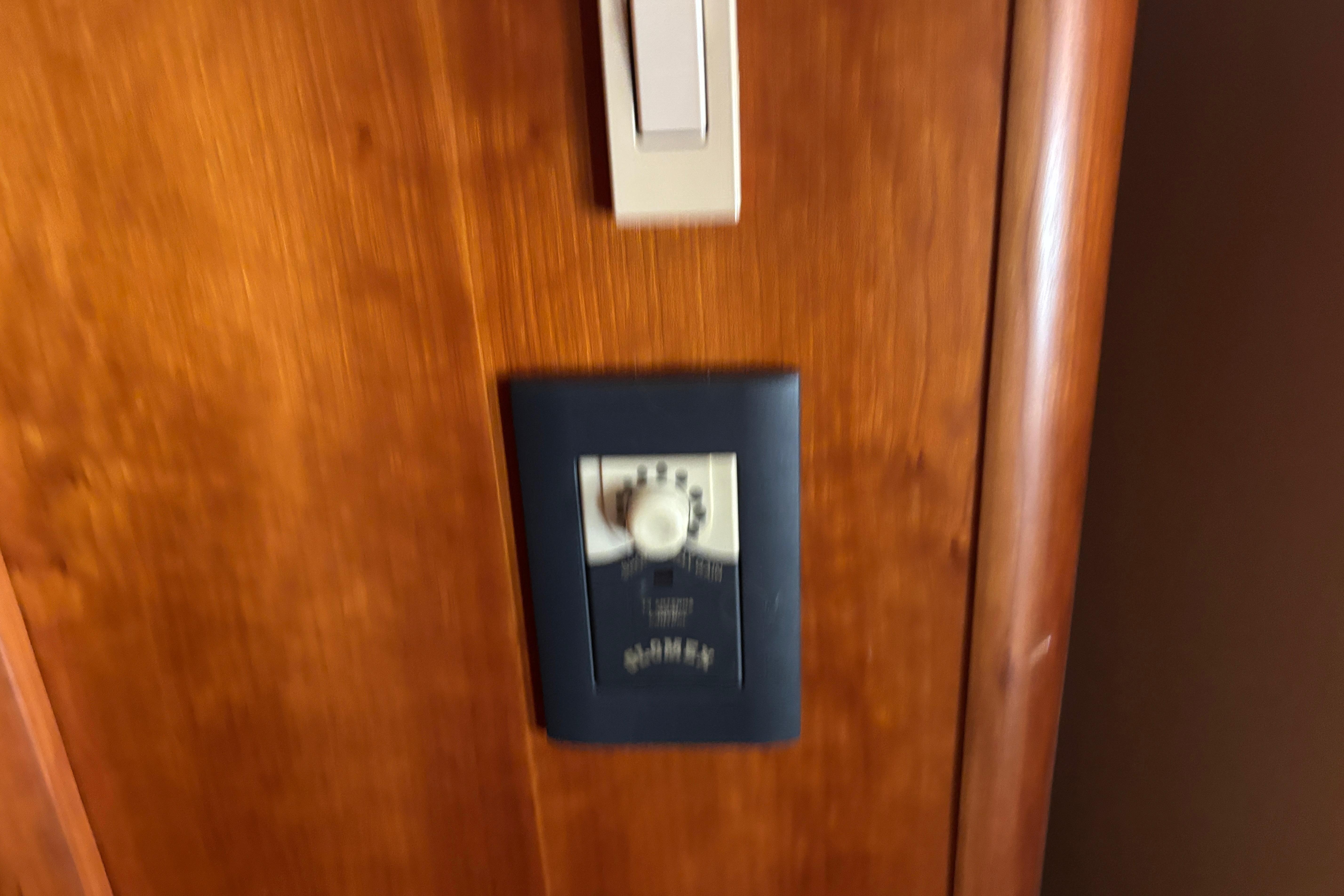 Wooden interior panel with a control switch on a 2001 Silverton 410 Sport Bridge.