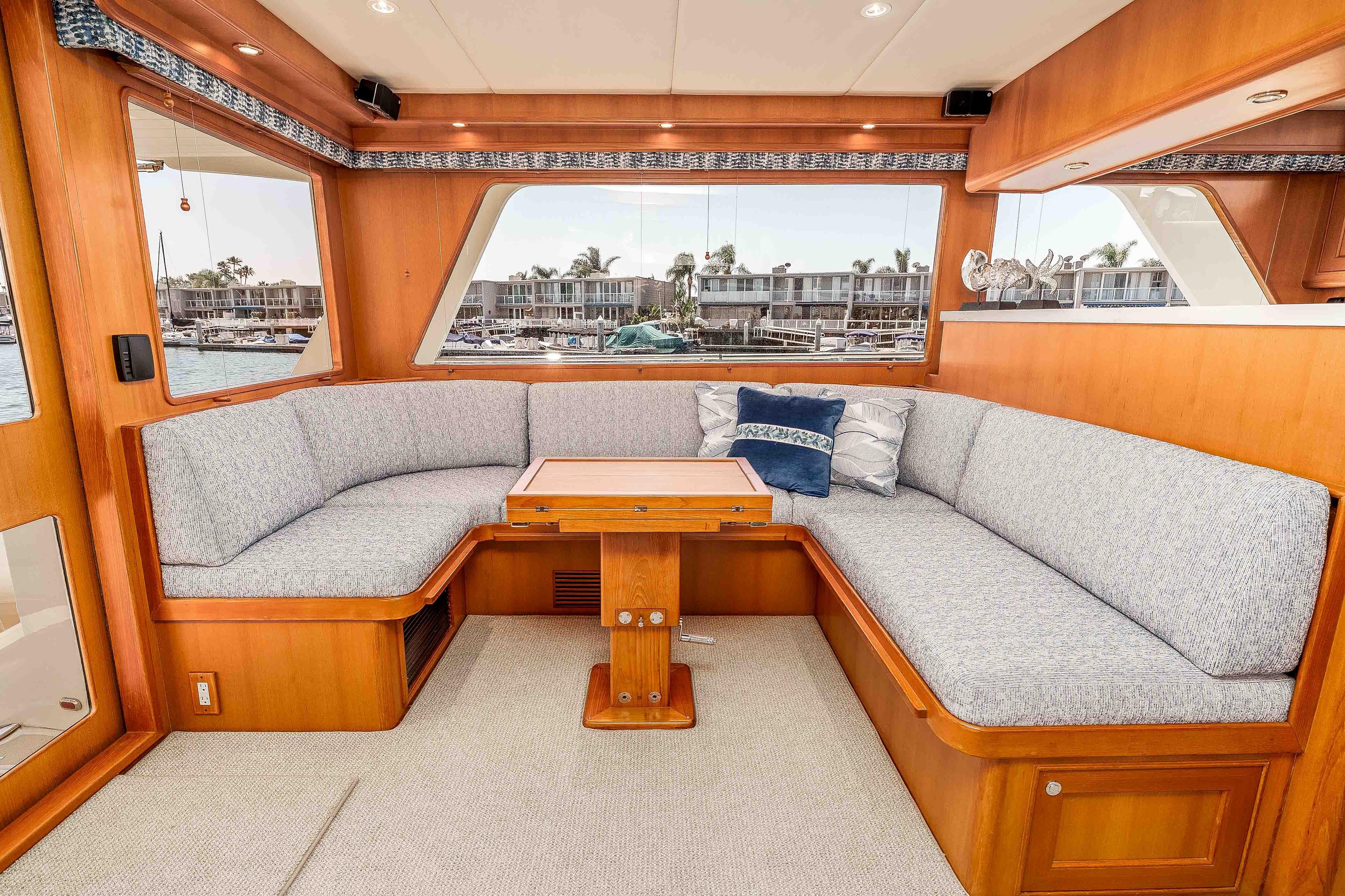 Luxurious interior of 2005 Offshore Yachts 54 Pilothouse with elegant seating and scenic window views.