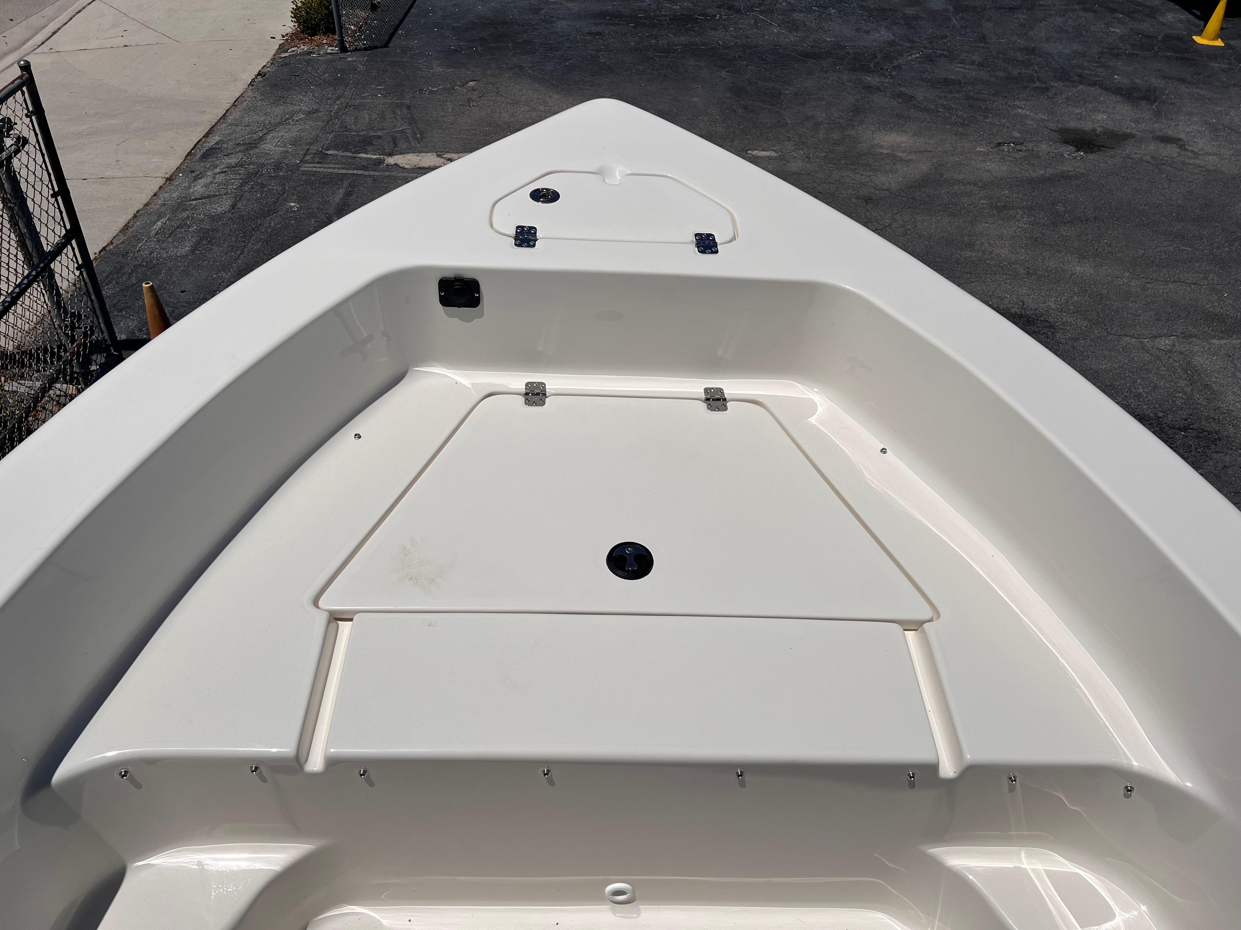 2025 Key West 179 FS boat deck, featuring storage compartments and sleek design.
