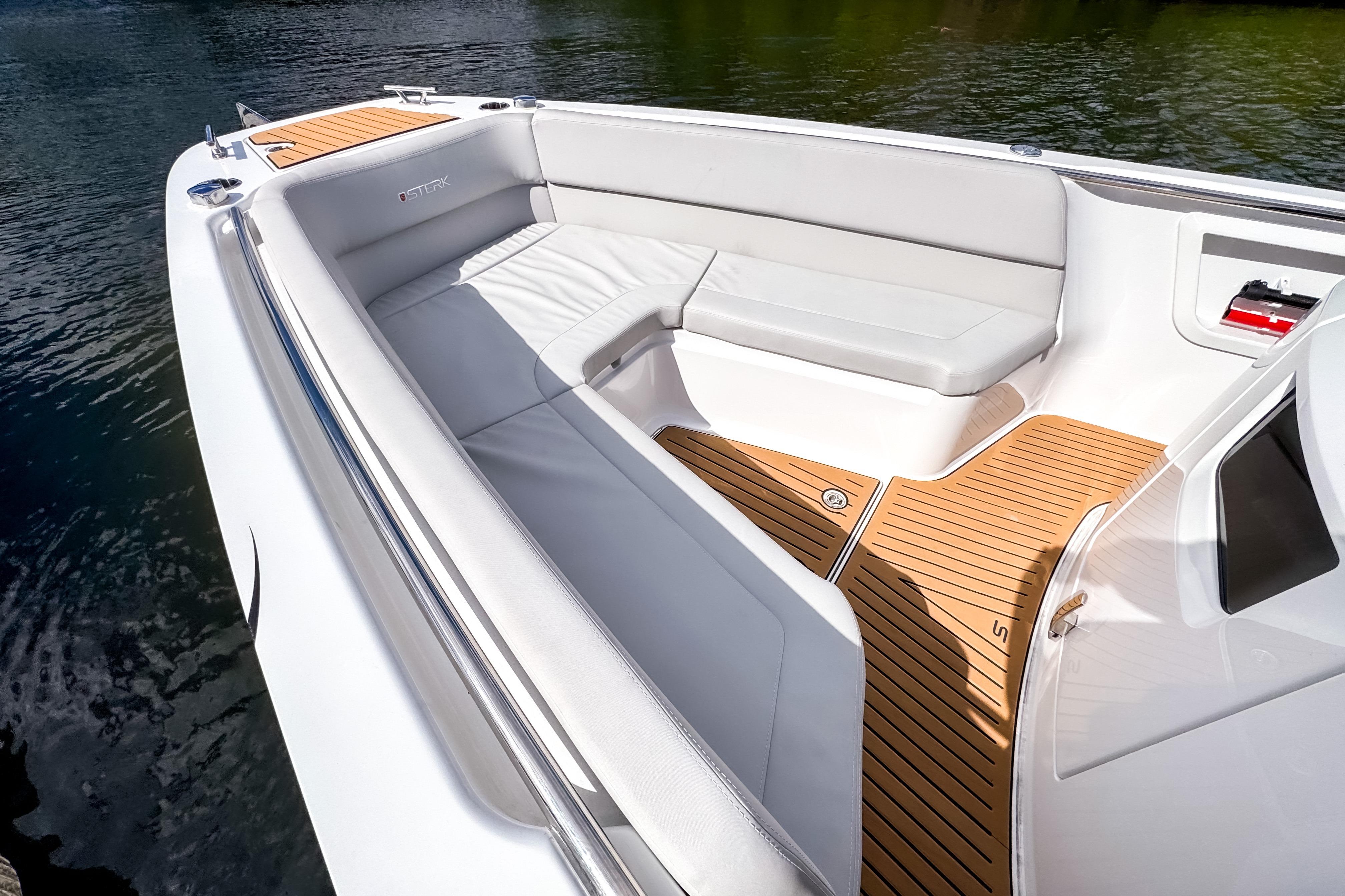 Luxurious 2025 STERK 31 boat interior with sleek seating and elegant wood flooring.