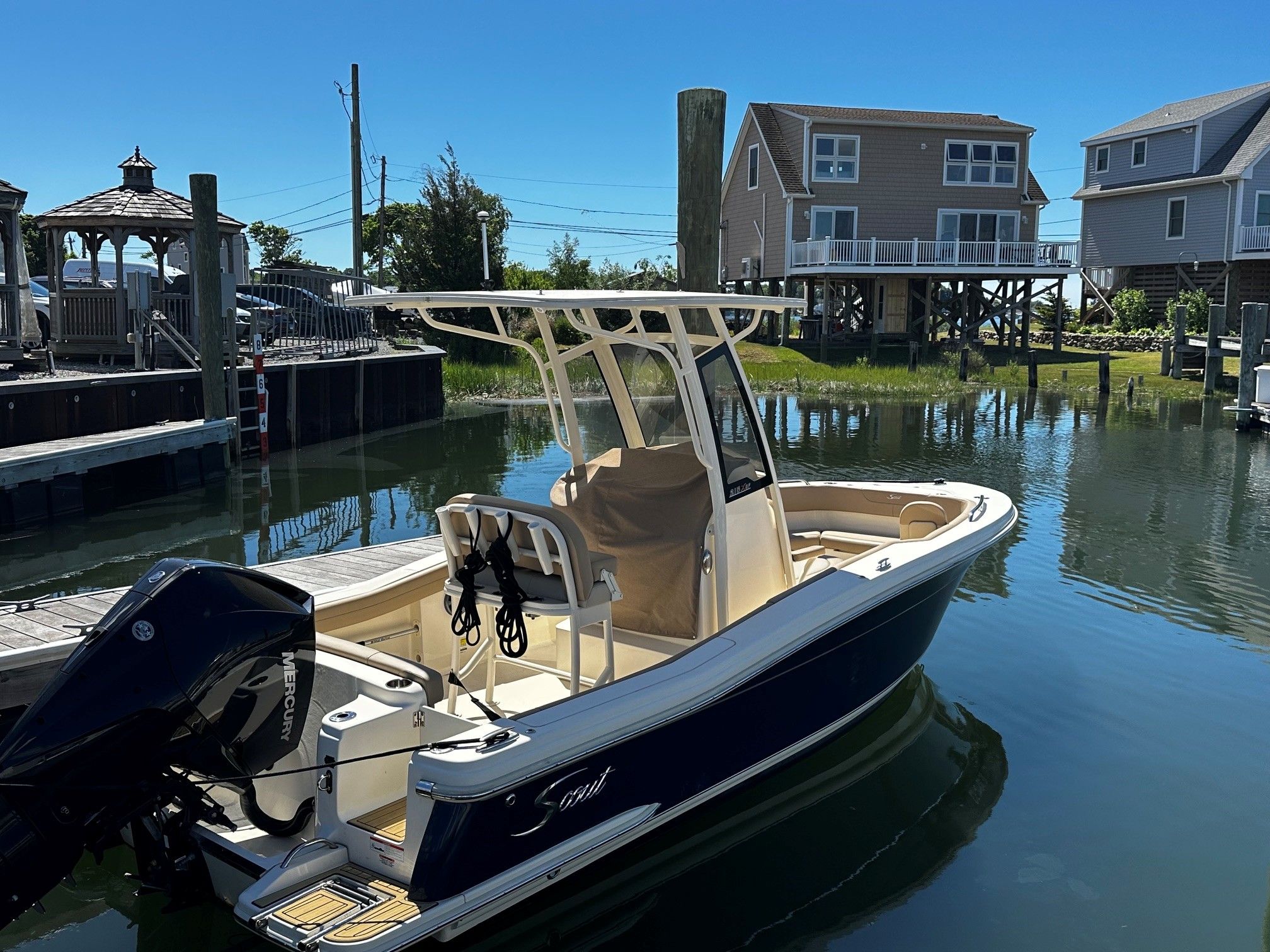 2022 Scout 210XSF boat on water, serene setting.