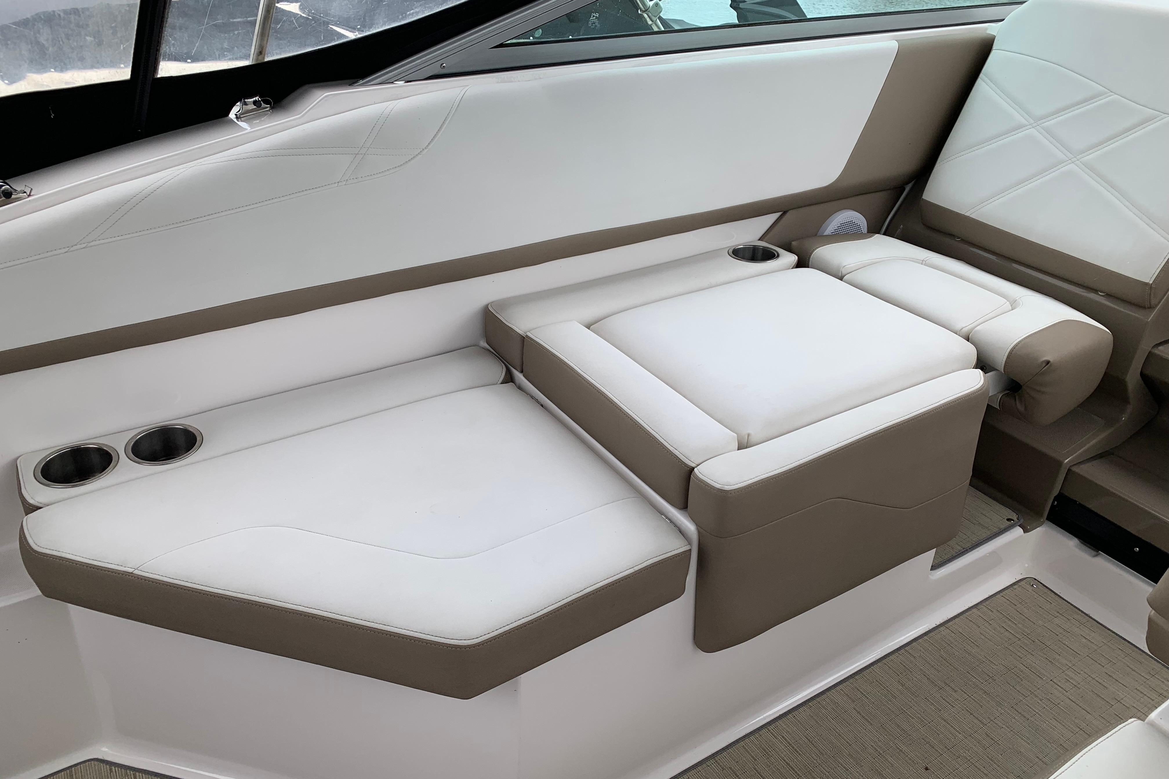 Luxurious seating on 2017 Regal 26 Express boat with cup holders and elegant design.
