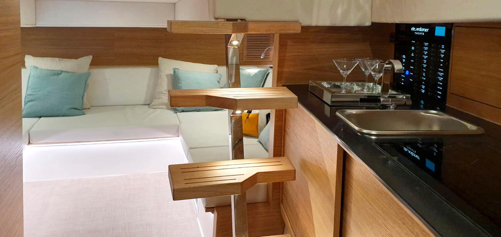 2024 De Antonio Yachts D42 Open interior with modern kitchen and cozy seating area.