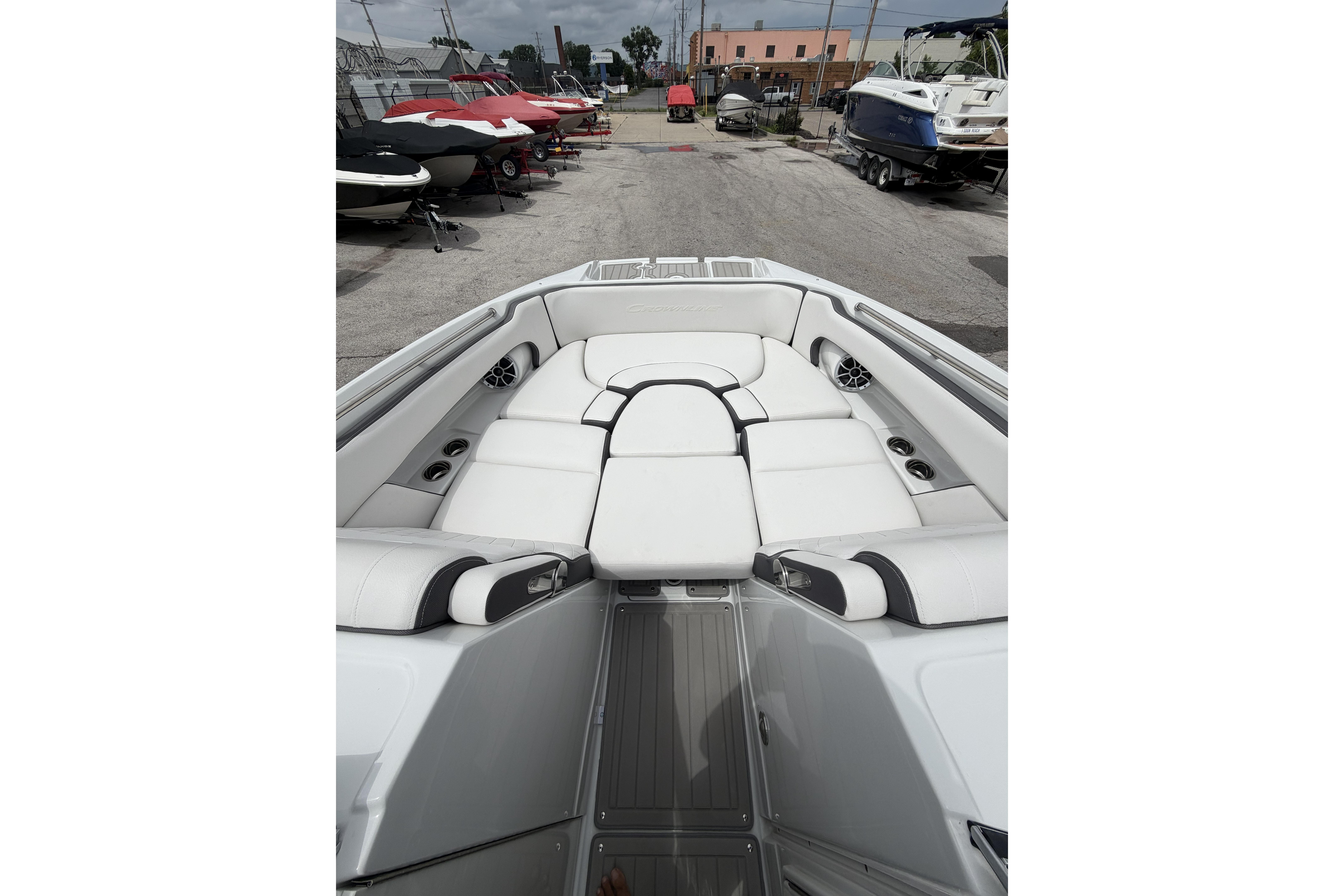 2026 Crownline Eclipse E275 boat interior with white cushioned seating and cup holders.