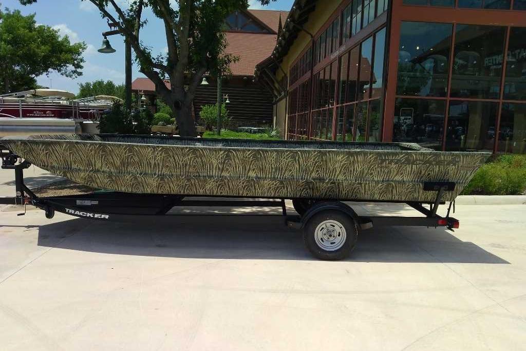 2025 Tracker Grizzly 2072 Utility boat with camouflage design on a trailer.