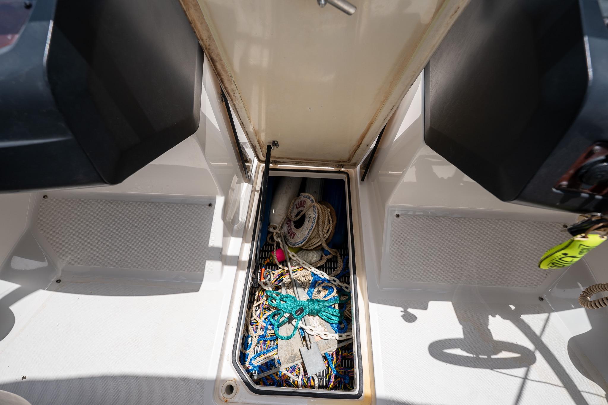 Storage compartment of a 2008 Regal 2000 Bowrider boat with ropes and equipment.