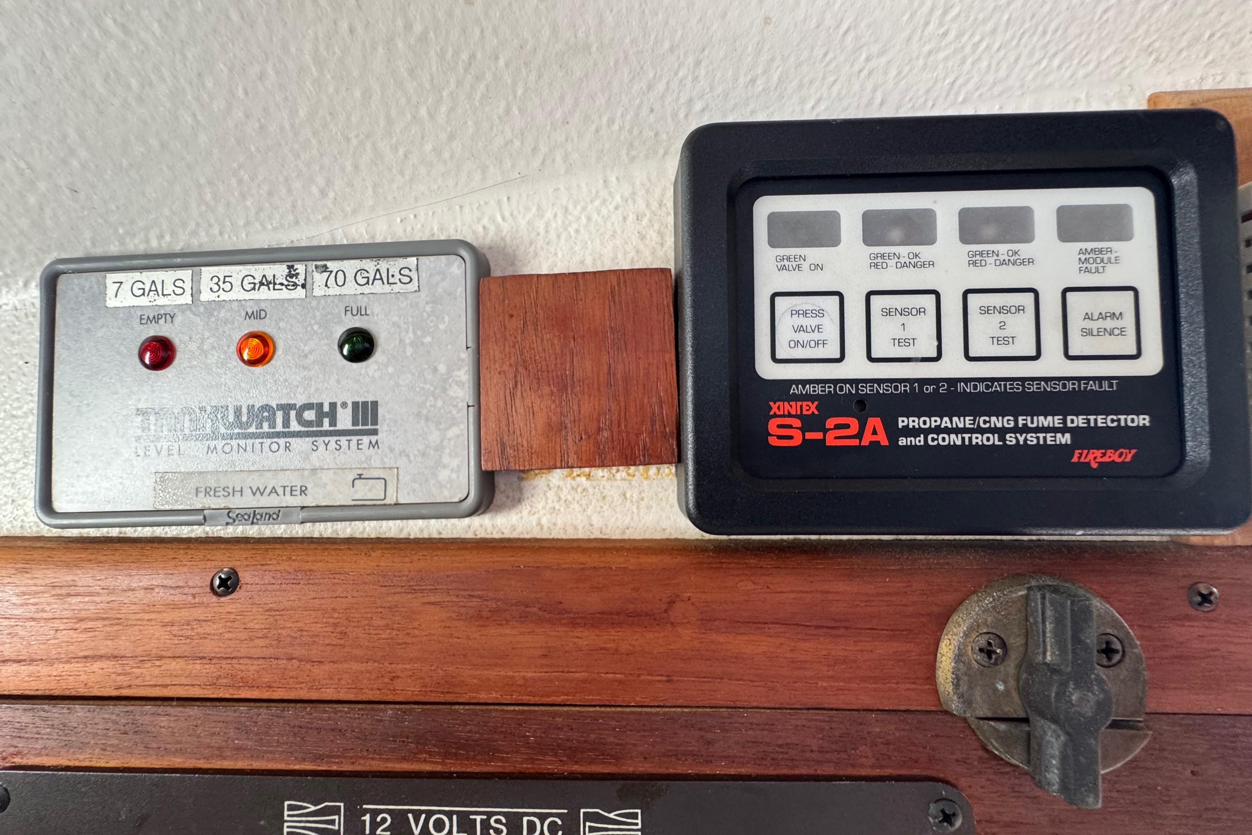 Control panels on a 1989 Cape Dory 30 Motorsailer, featuring water level and fume detection systems.