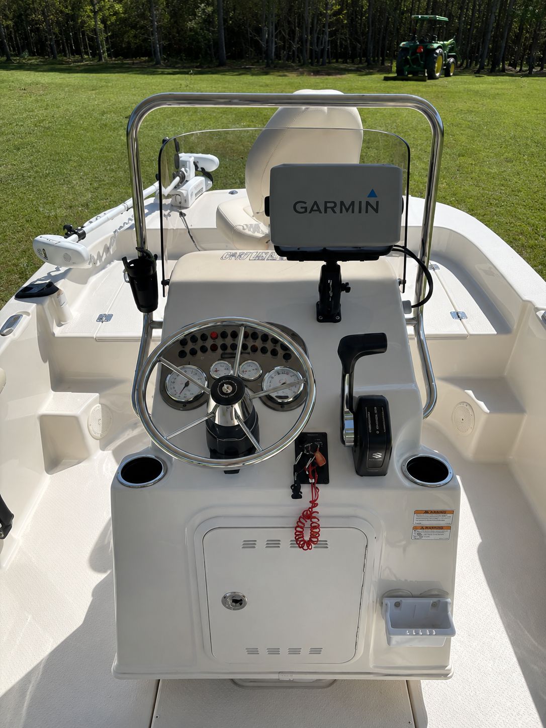 The image shows the helm of a Carolina Skiff 17 LS boat with a Garmin navigation system.