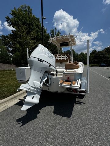 2025 Pioneer ISLANDER 202 boat with outboard motor on a sunny day.