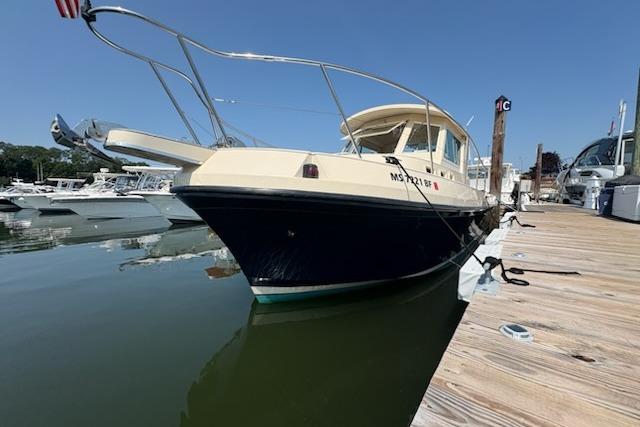 2003 Albin 28 Tournament Express docked at a marina under clear blue skies.