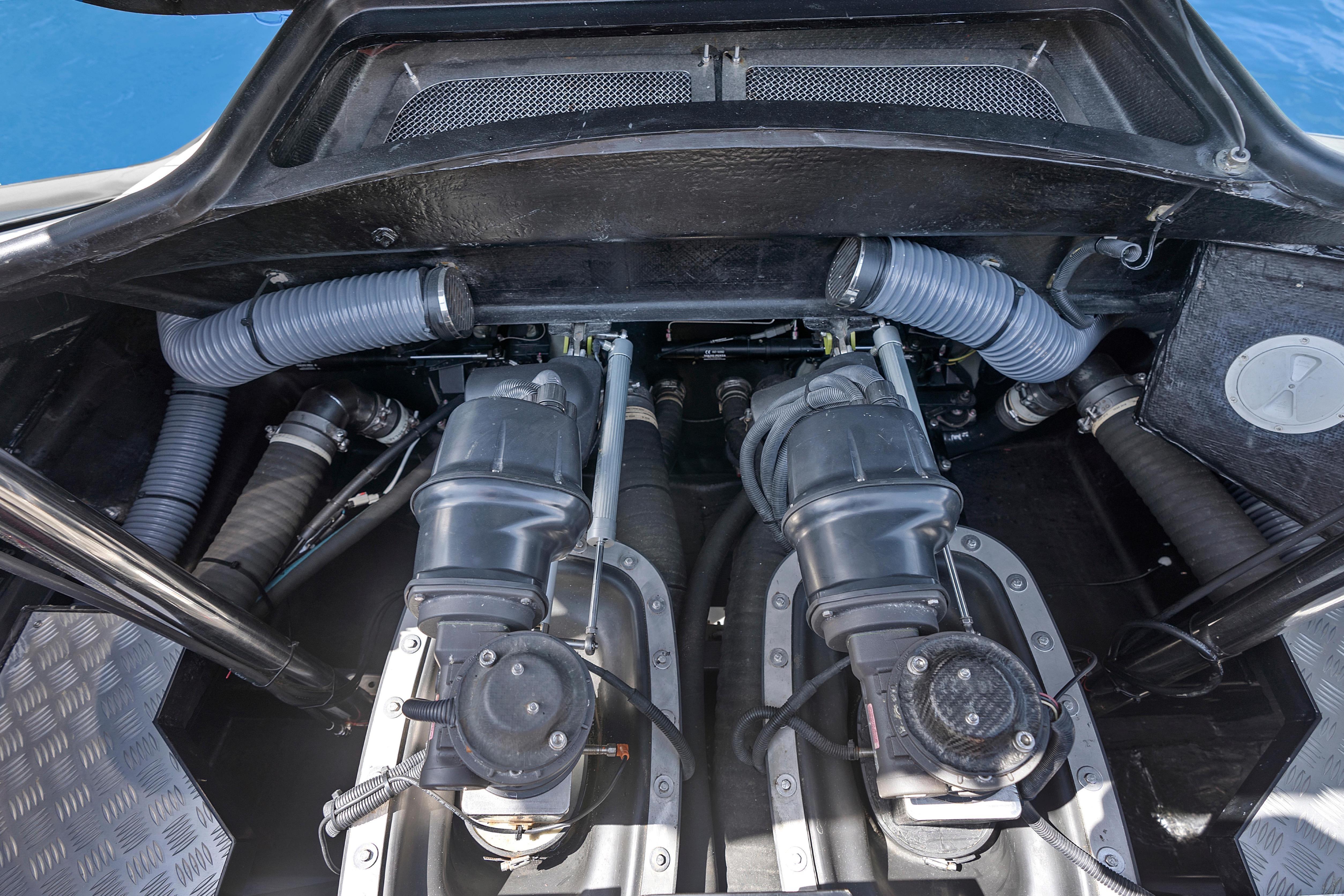 Engine compartment of a 2020 Princess R35 yacht, showcasing dual engines and ventilation hoses.