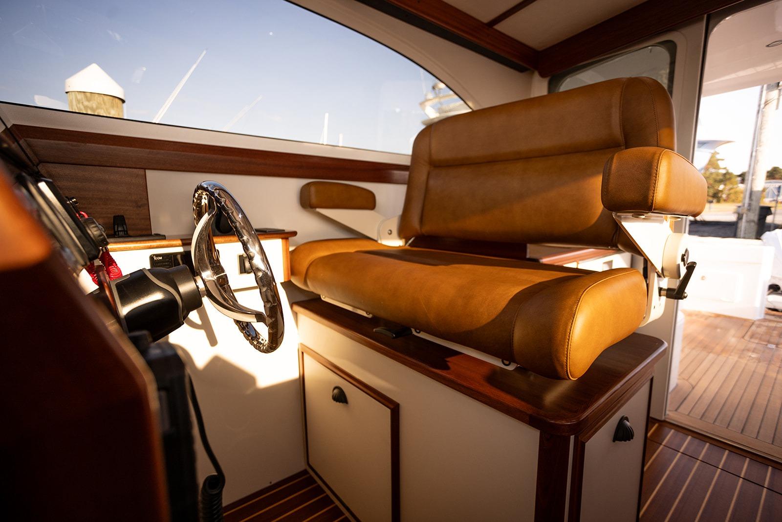 Luxurious interior of 2027 Composite Yacht CY39 with leather seating and polished steering wheel.