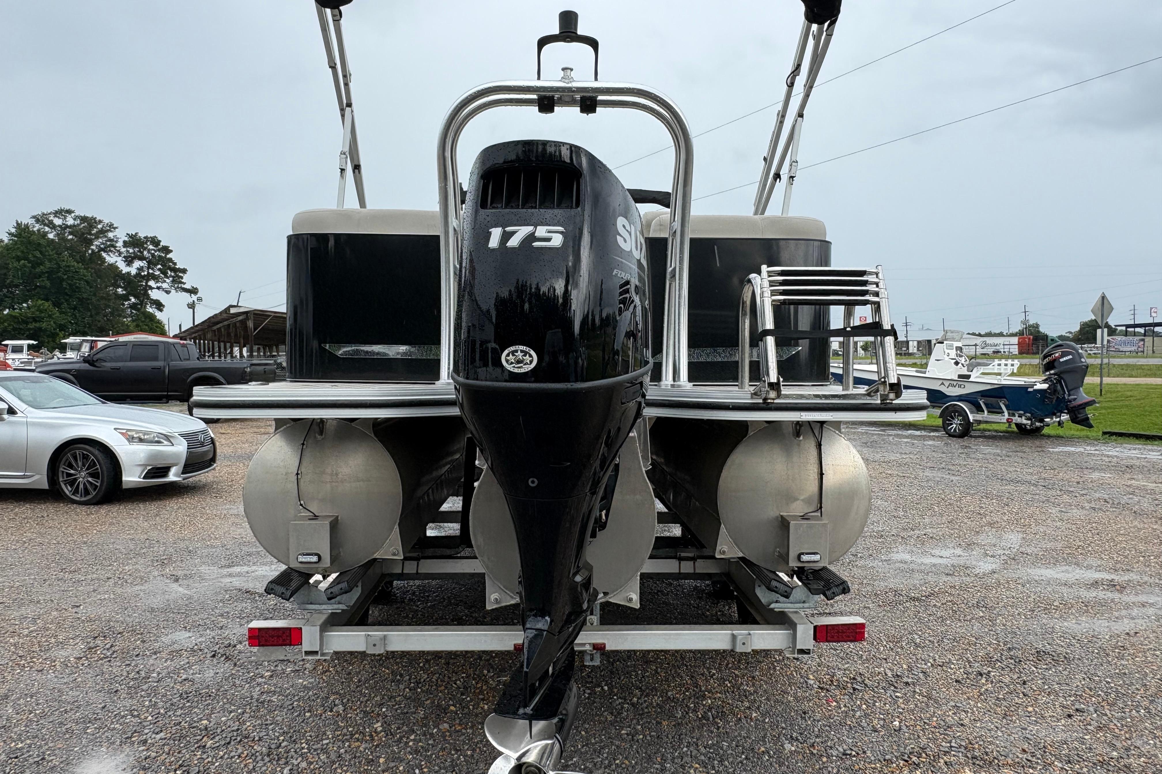 2023 SilverWave 2410 CLS pontoon boat with 175 HP engine, parked on a trailer.