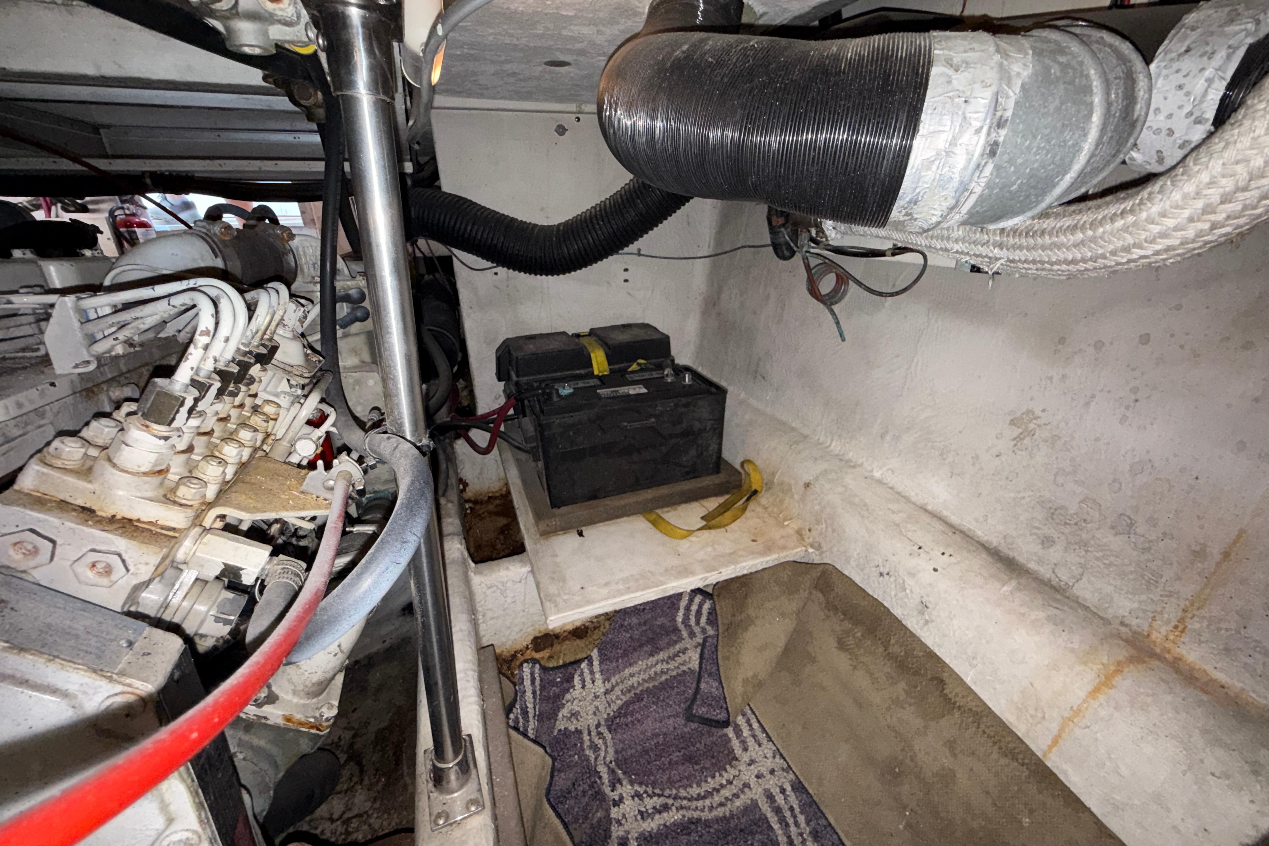 Engine room of 1997 Bayliner 3988 Command Bridge Motoryacht with battery and mechanical components.