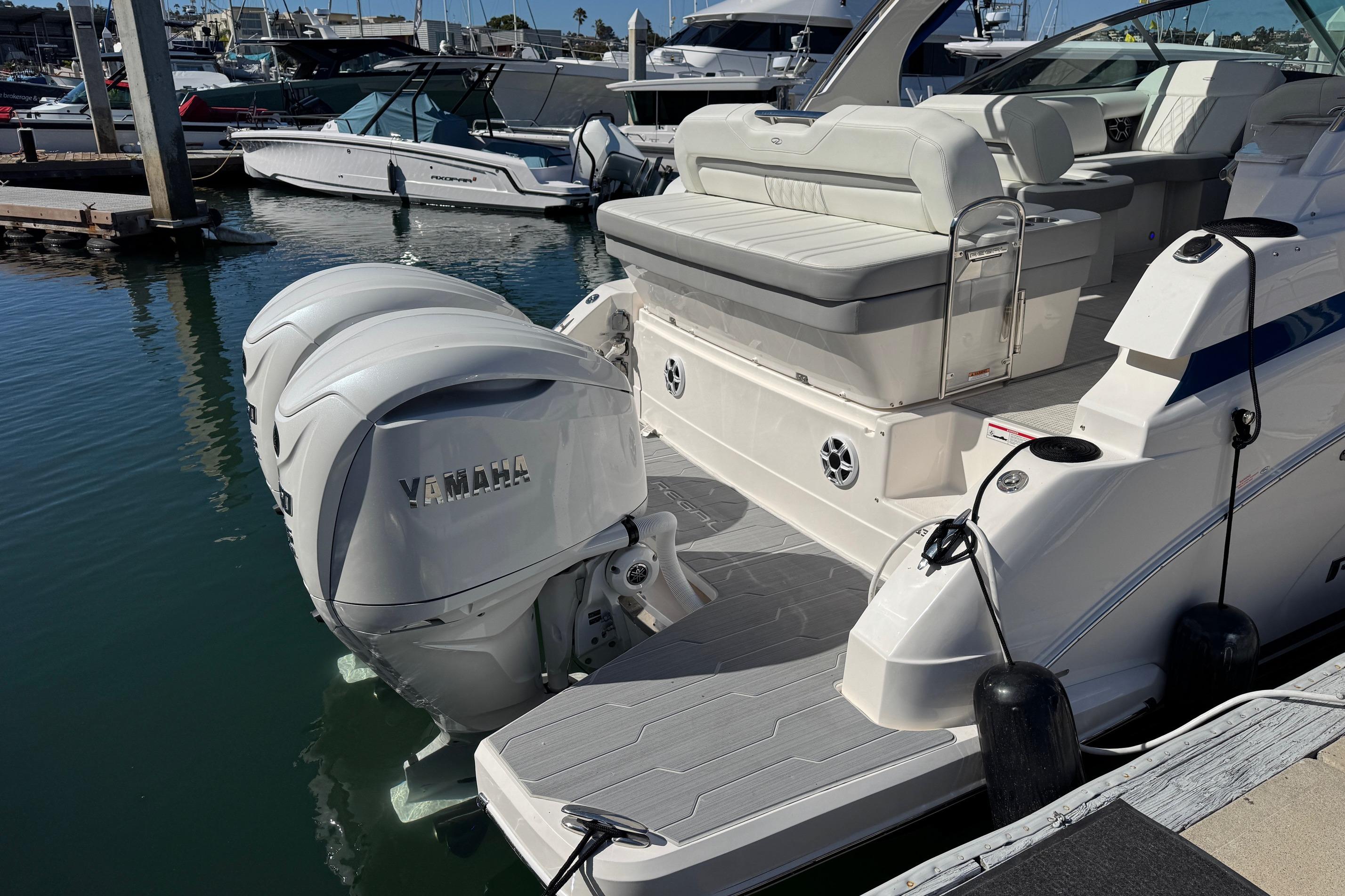 2026 Regal 33 XO boat with Yamaha outboard engines docked at marina.