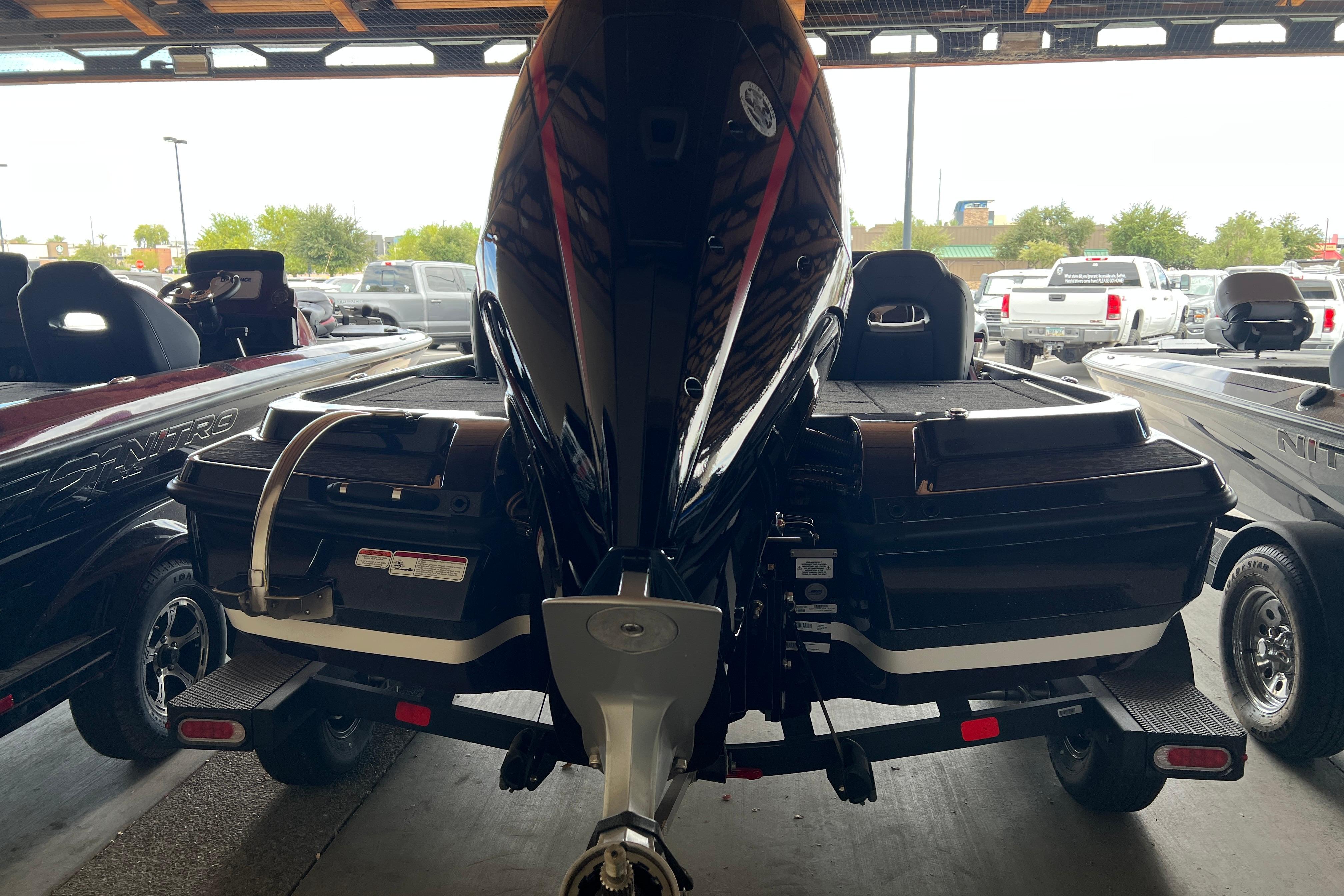 2026 Nitro Z20 XL boat in showroom, rear view with motor and trailer.