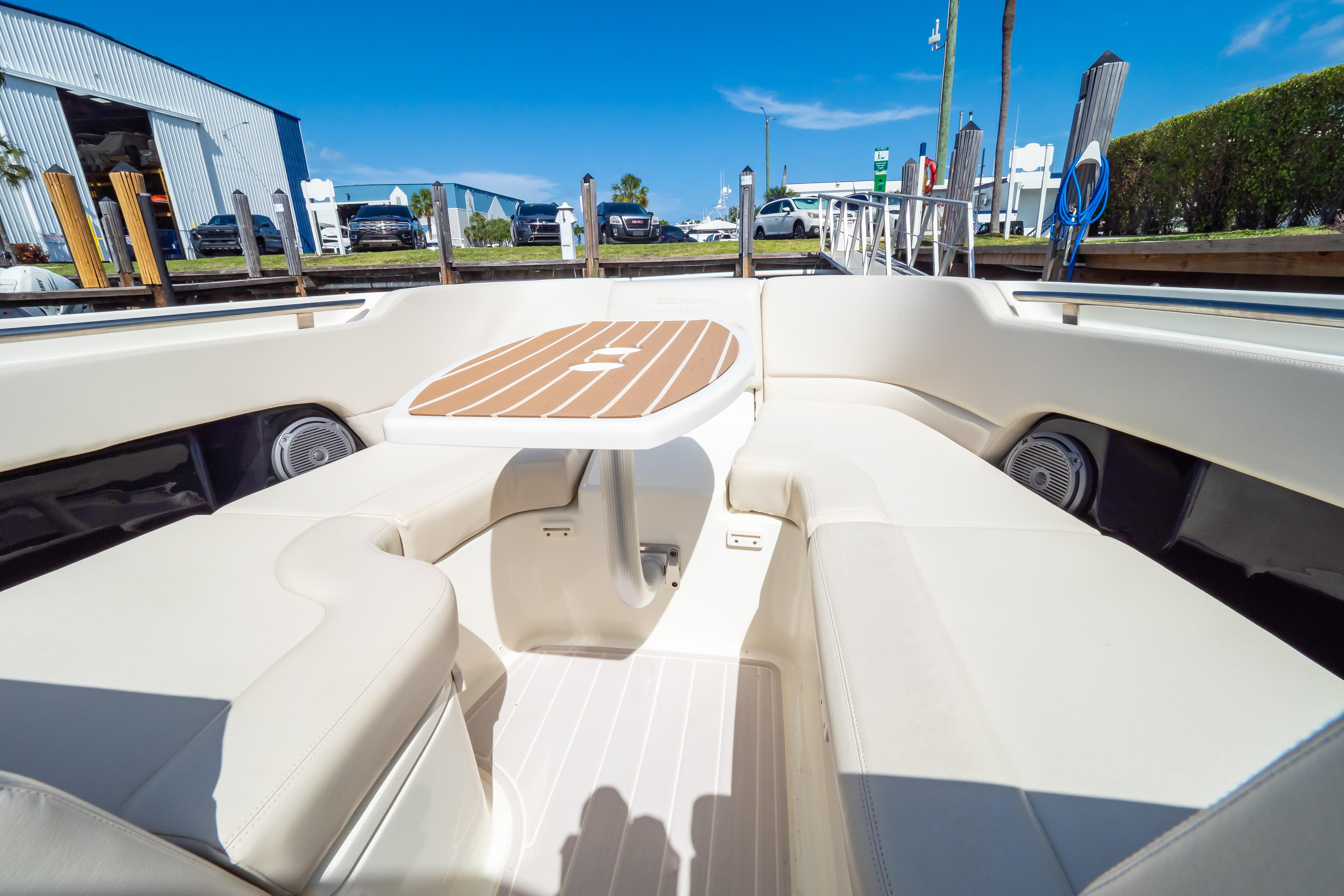 2019 Boston Whaler 270 Vantage boat interior with cushioned seating and table.