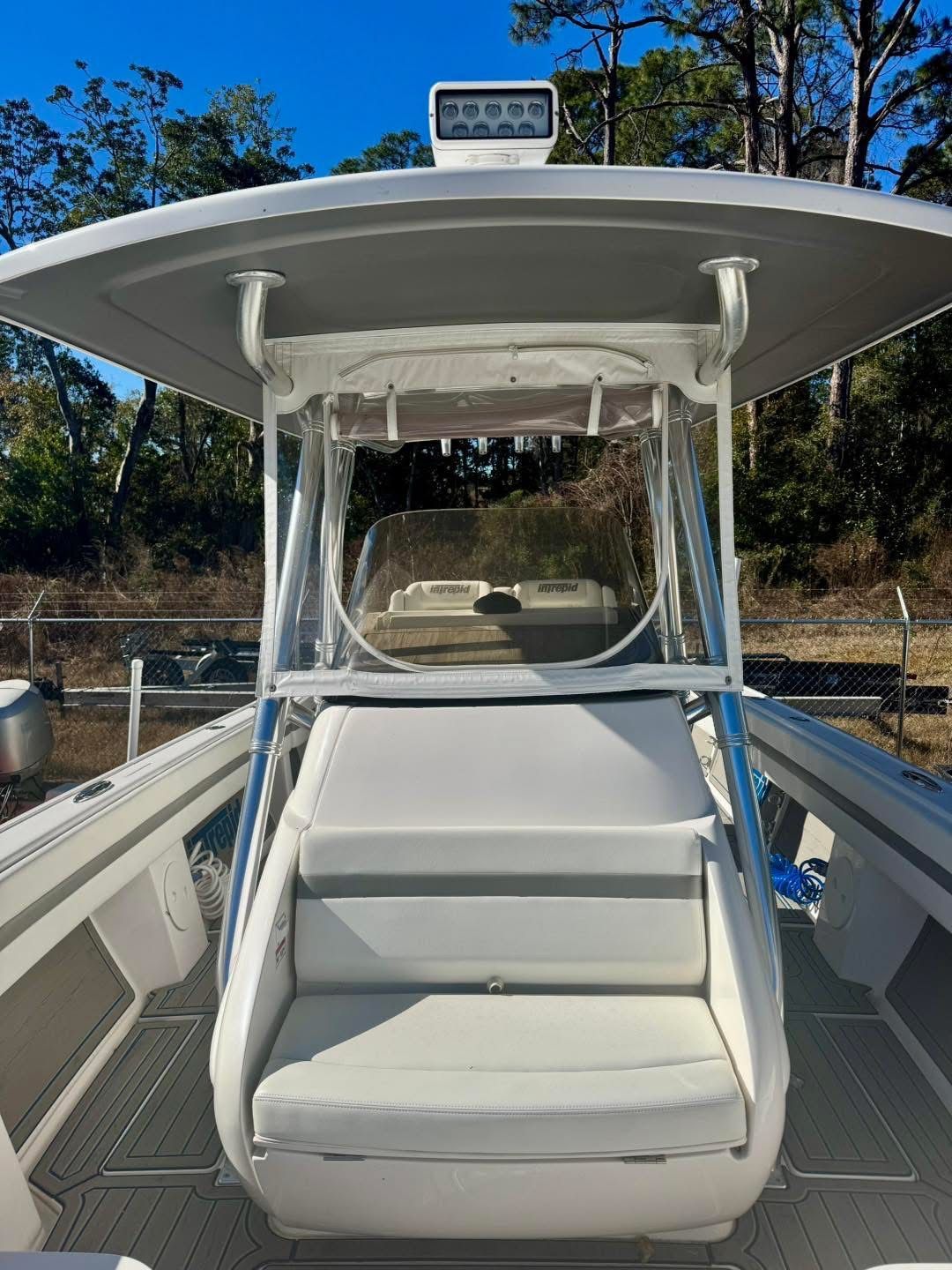 Intrepid 327 Nomad 2021 boat with seating area and canopy.