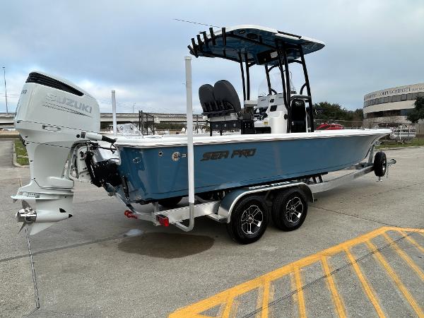 2024 Sea Pro 250 DLX boat with Suzuki outboard motor on trailer.