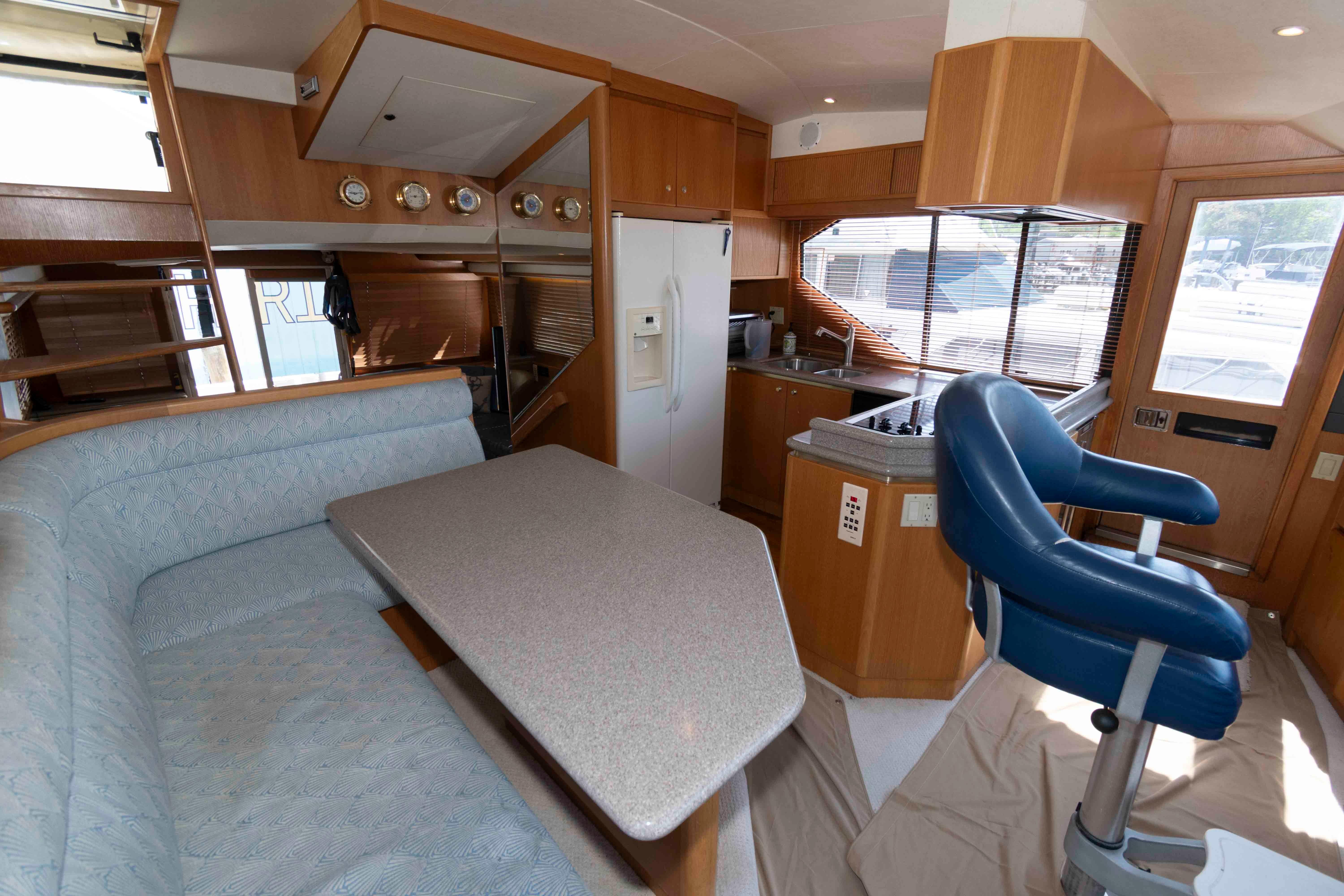 1999 West Bay 58 Sonship Pilothouse MY interior with kitchen and seating area.