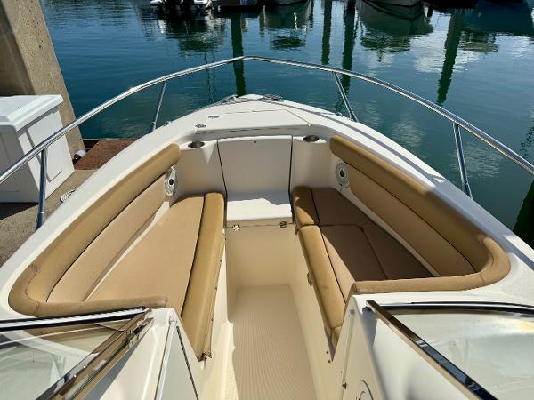 2016 Scout 245 Dorado boat with tan seating at a marina.
