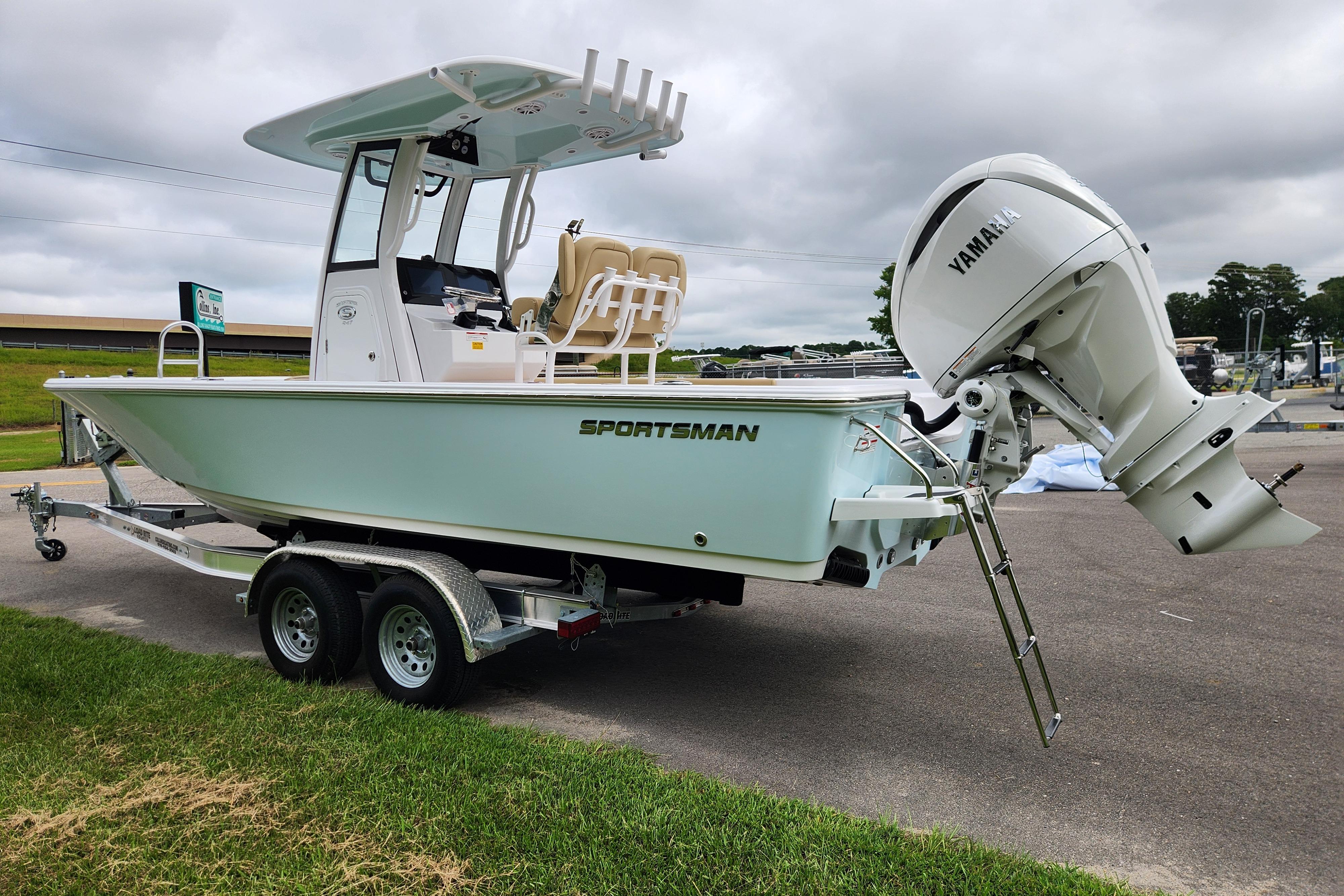 2026 Sportsman Masters 247 Bay Boat with Yamaha engine on trailer, parked outdoors.