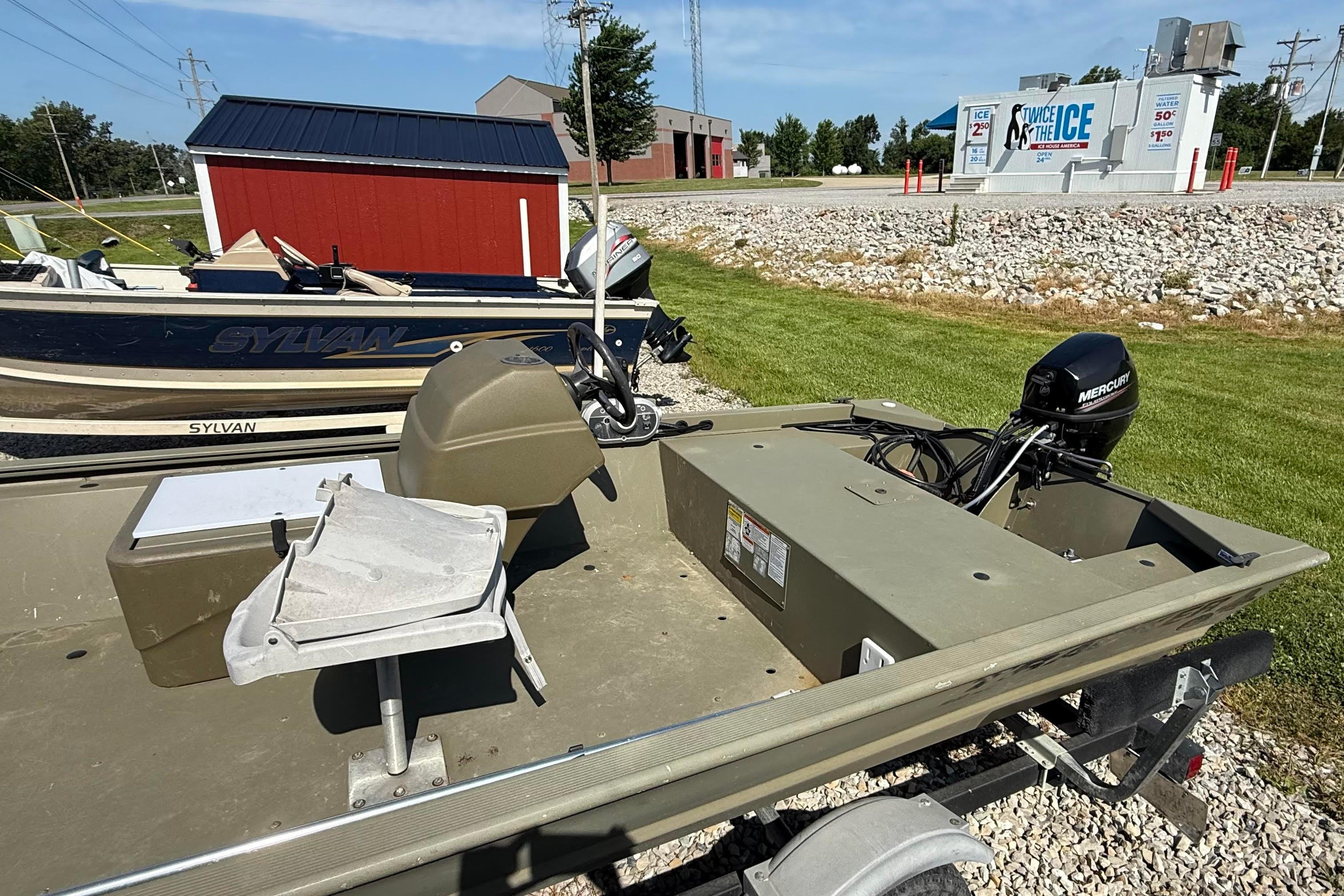 2019 Tracker Grizzly 1648 SC boat with Mercury outboard motor on display outdoors.