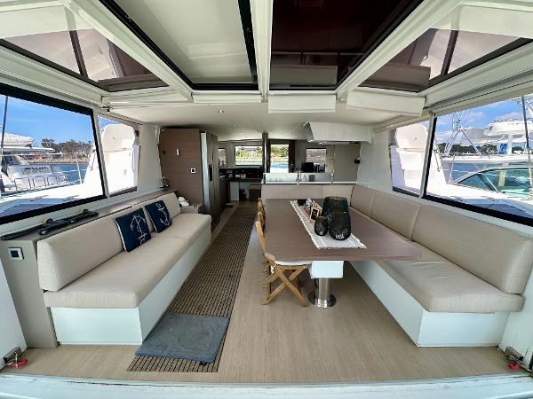 Luxurious interior of a 2021 Bali 4.8 catamaran with spacious seating and dining area.