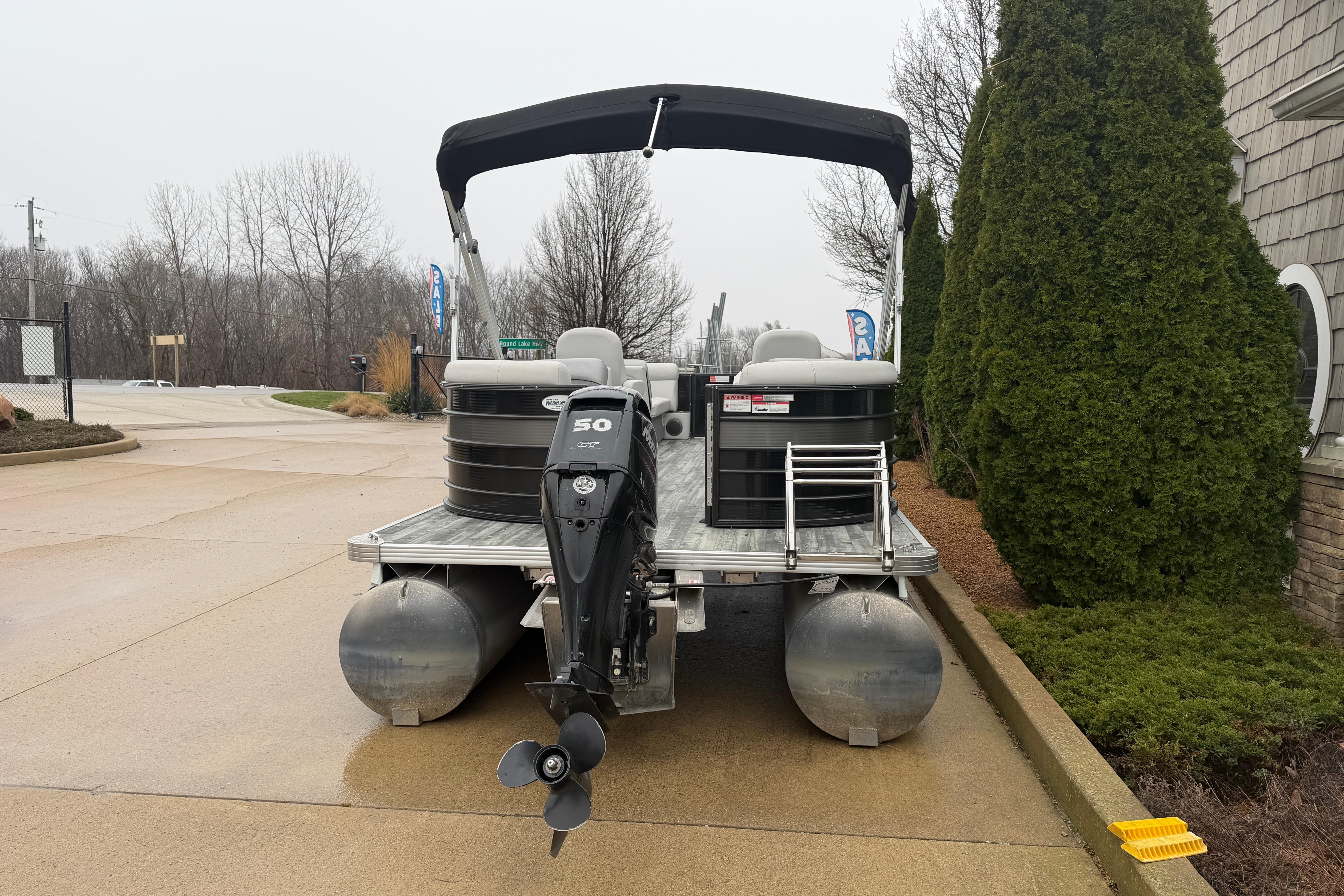 2019 Crest II SLC LTD pontoon boat with outboard motor, parked on a paved area.
