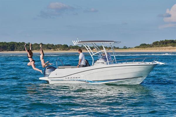 2023 Jeanneau Leader 6.5 CC S3 boat with people jumping into the water.