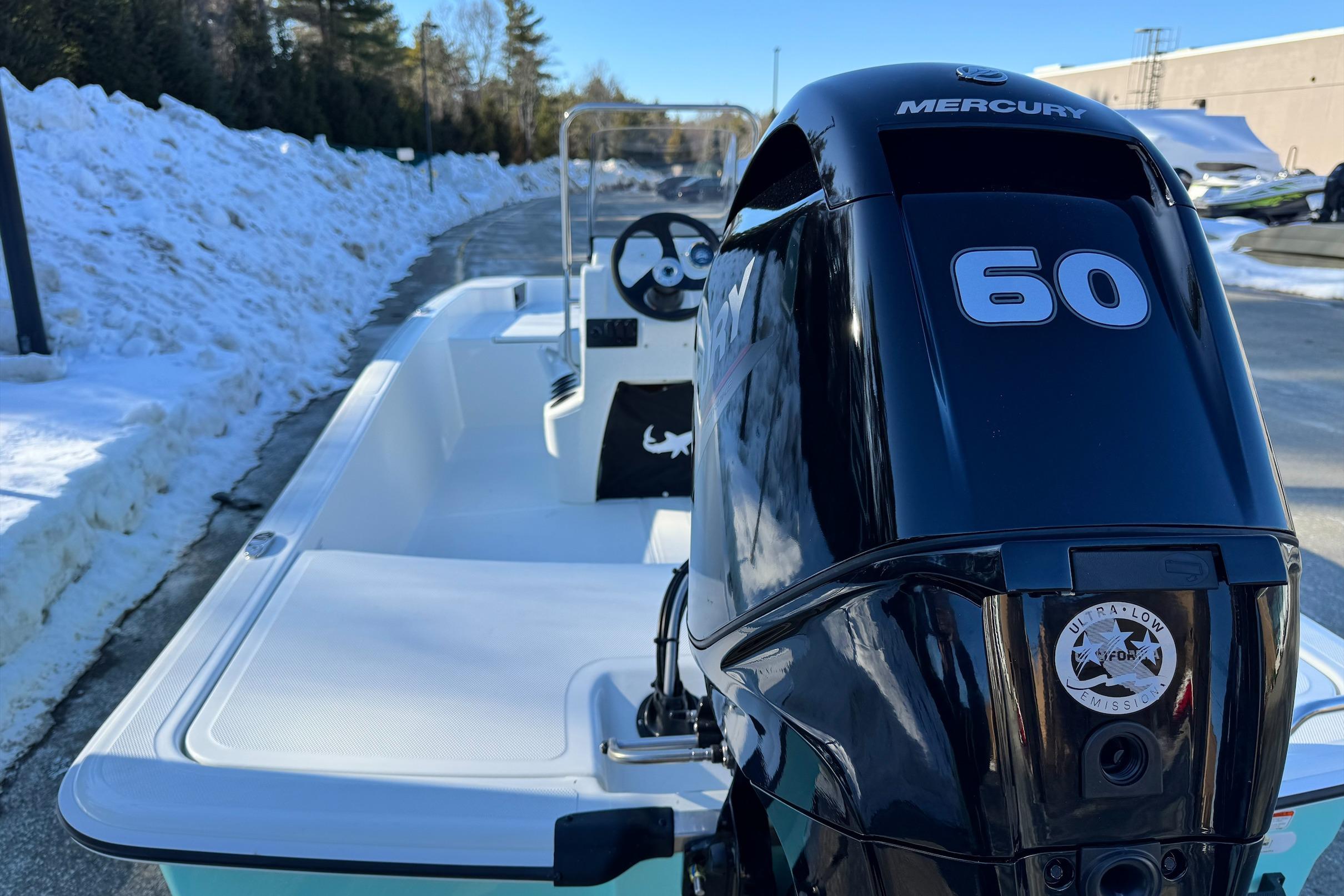 2026 Mako Pro Skiff 15 CC with Mercury 60 engine, parked on snowy road.
