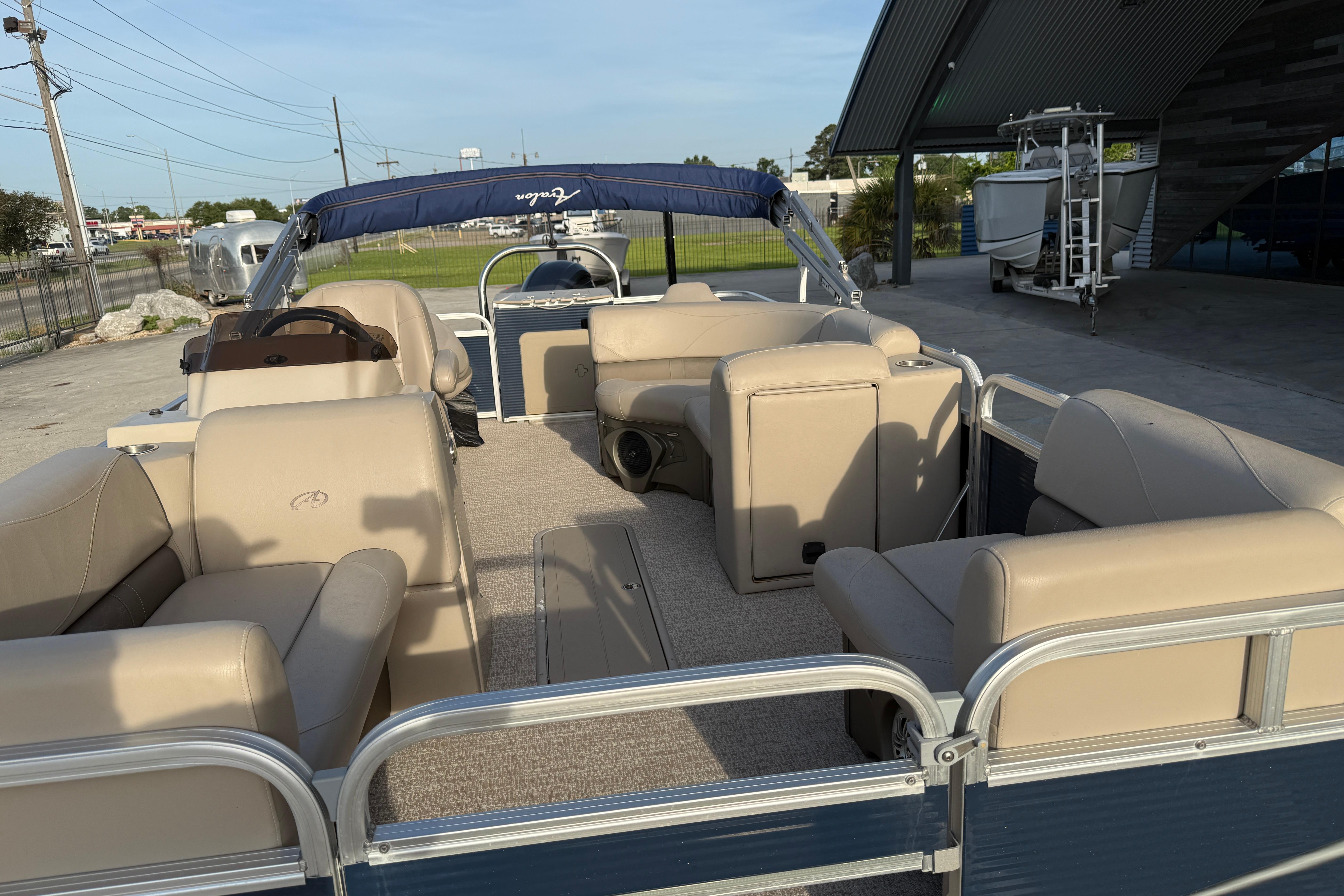 2019 Avalon Venture Fish N Cruise 20' pontoon boat with beige seating and canopy.