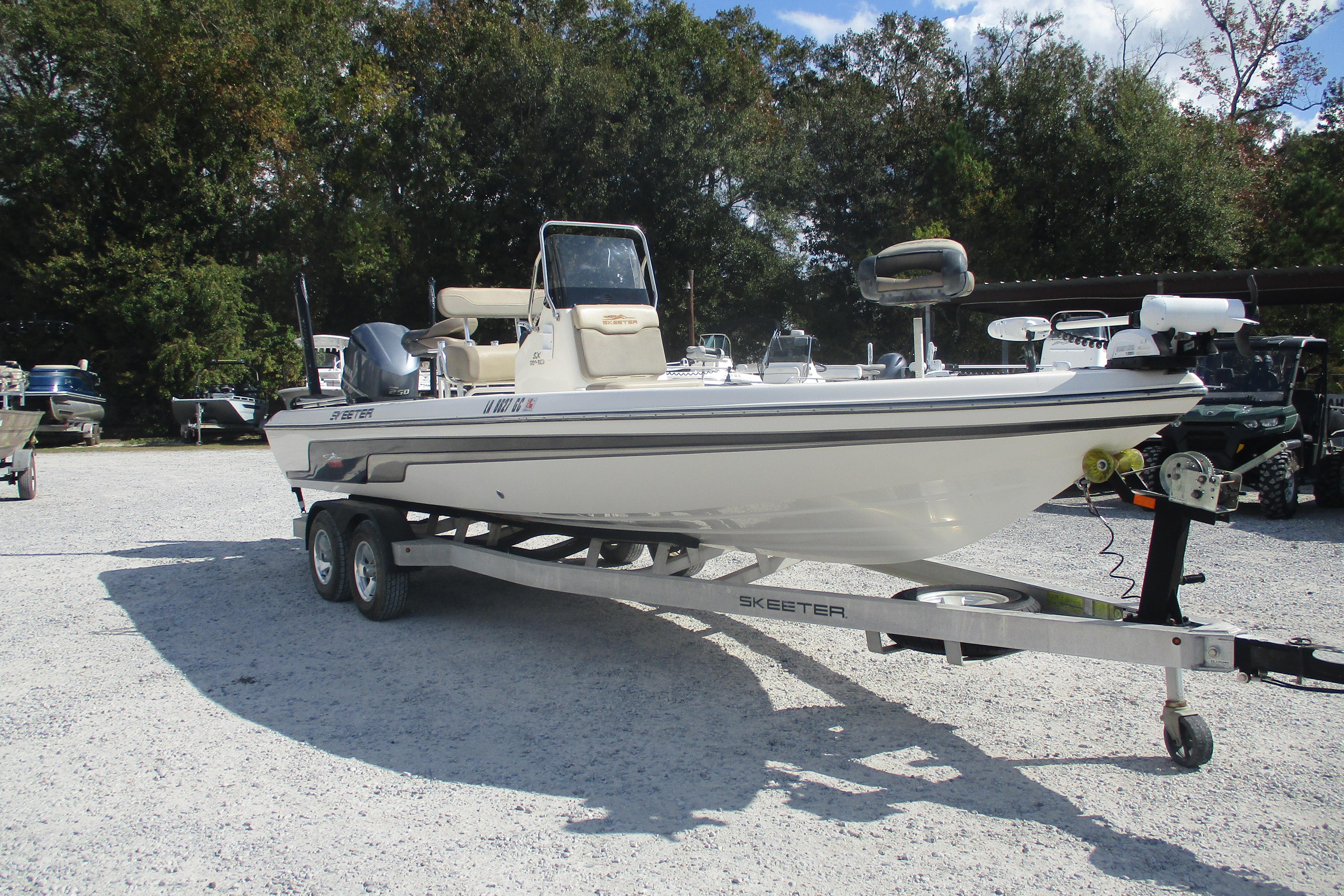 2014 Skeeter SX240 boat on trailer in outdoor setting.