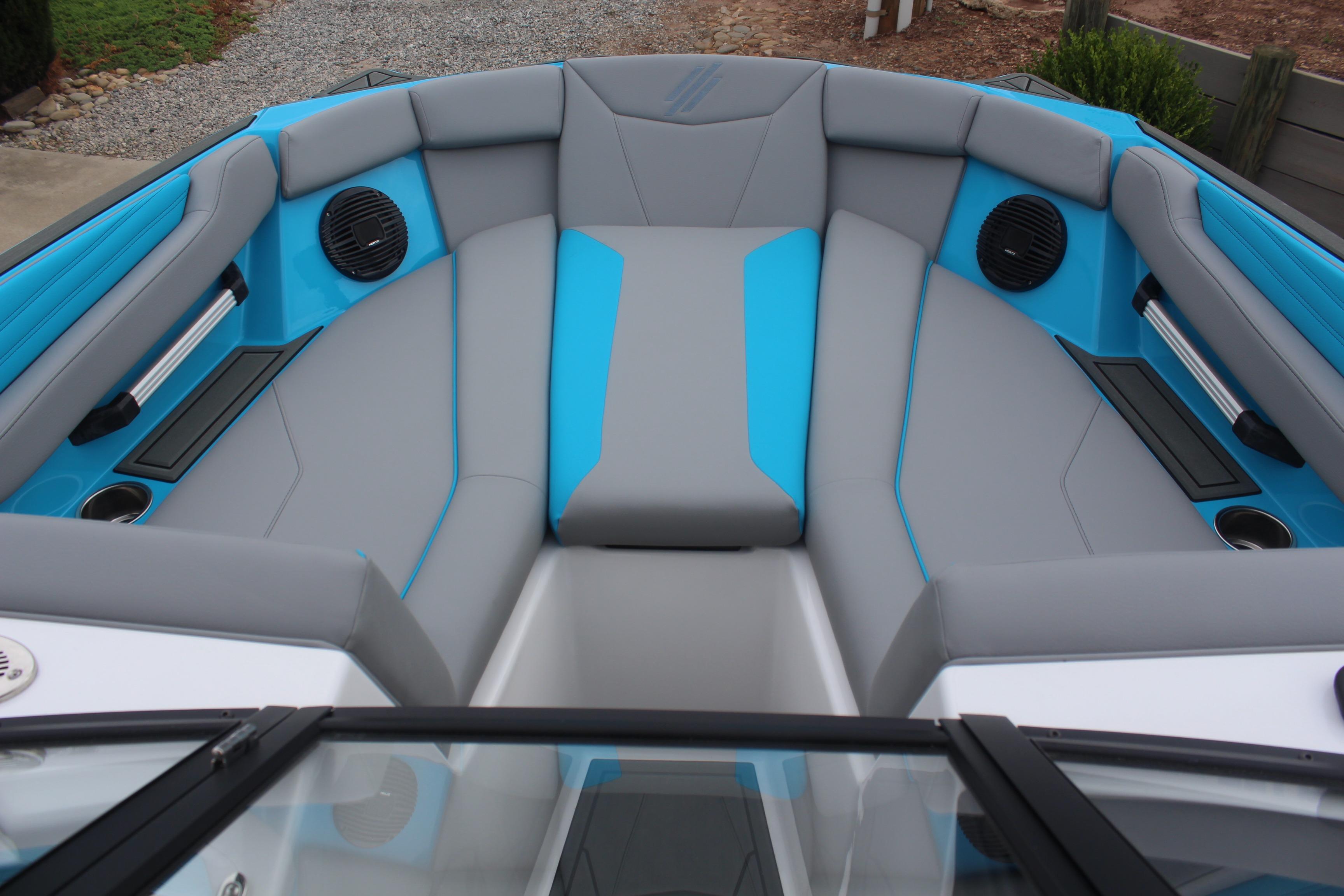 Interior of 2026 ATX Surf Boats 22 Type-S, featuring gray and blue seating with speakers.