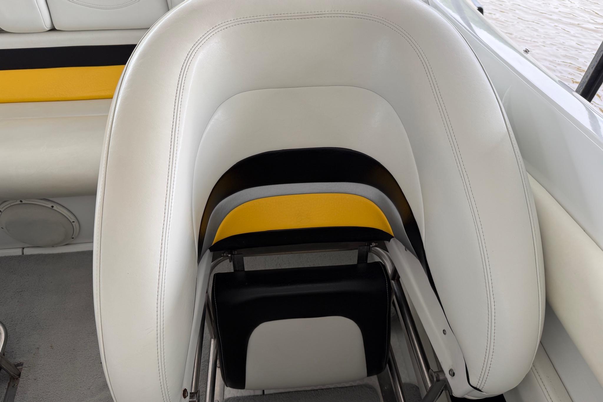 White and yellow seating on a 2001 Baja 33 Outlaw boat interior.
