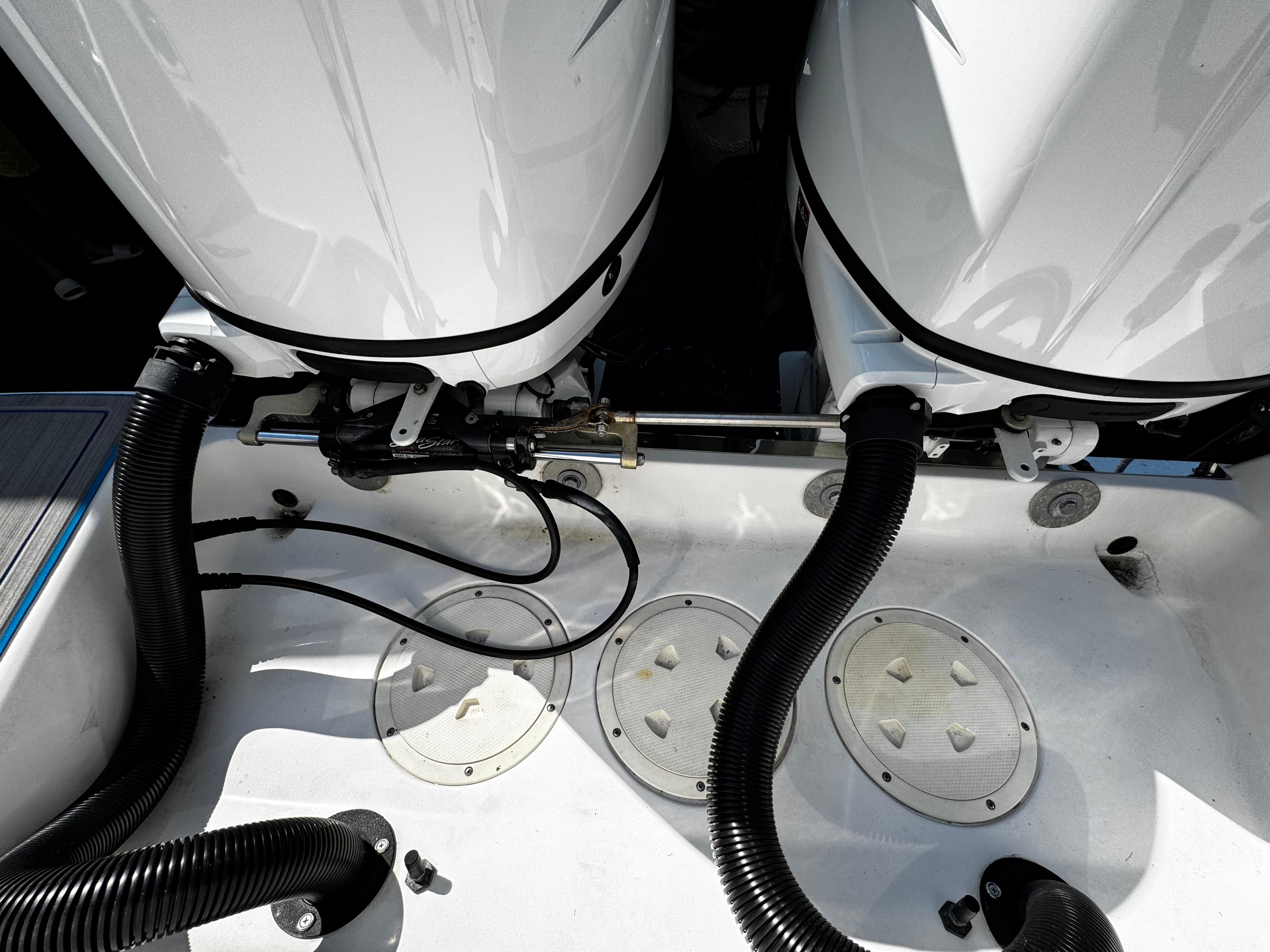 Twin outboard motors on a 2004 Robalo R 260 boat, showcasing engine connections.