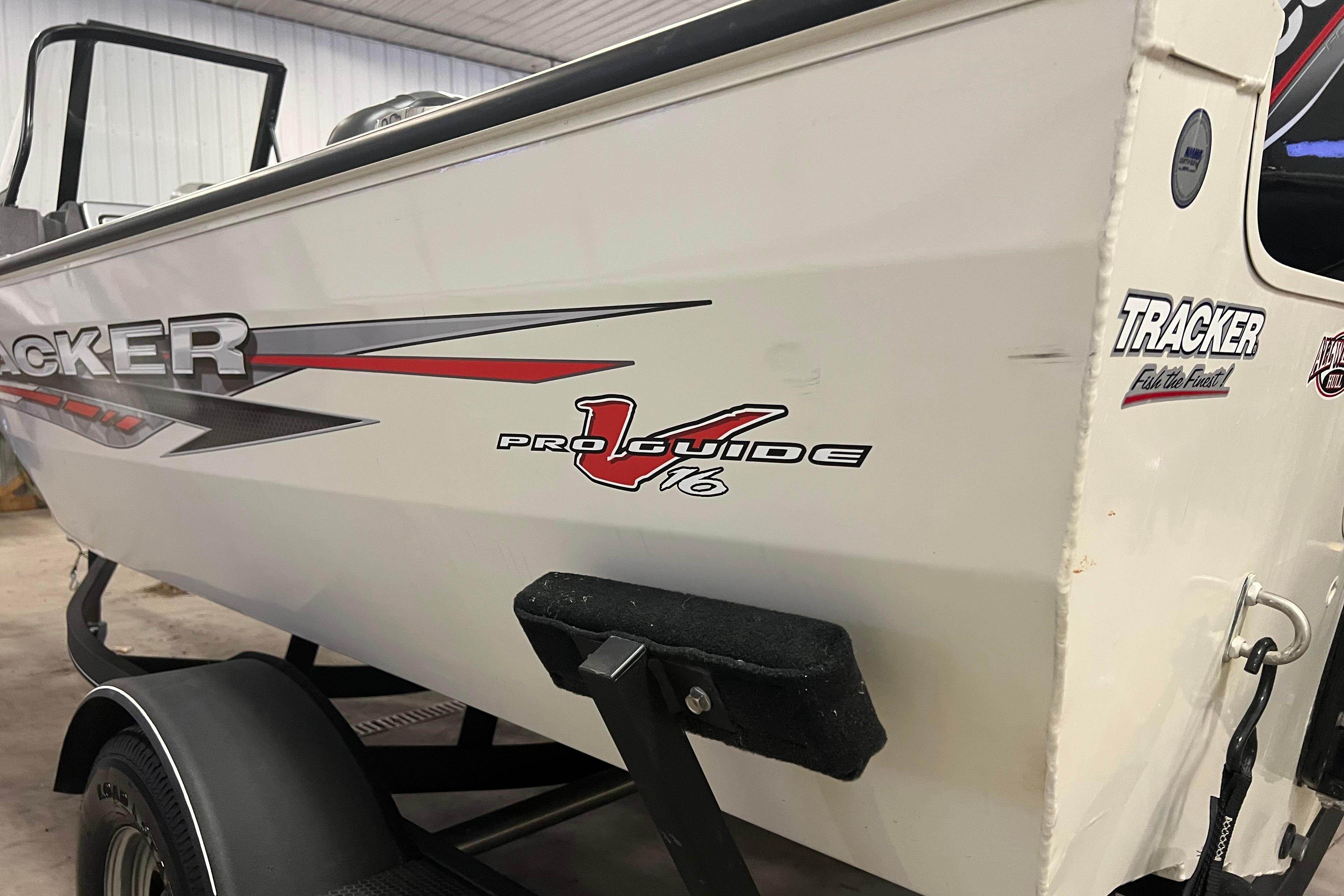 2022 Tracker Pro Guide V-16 WT boat on trailer in indoor setting.