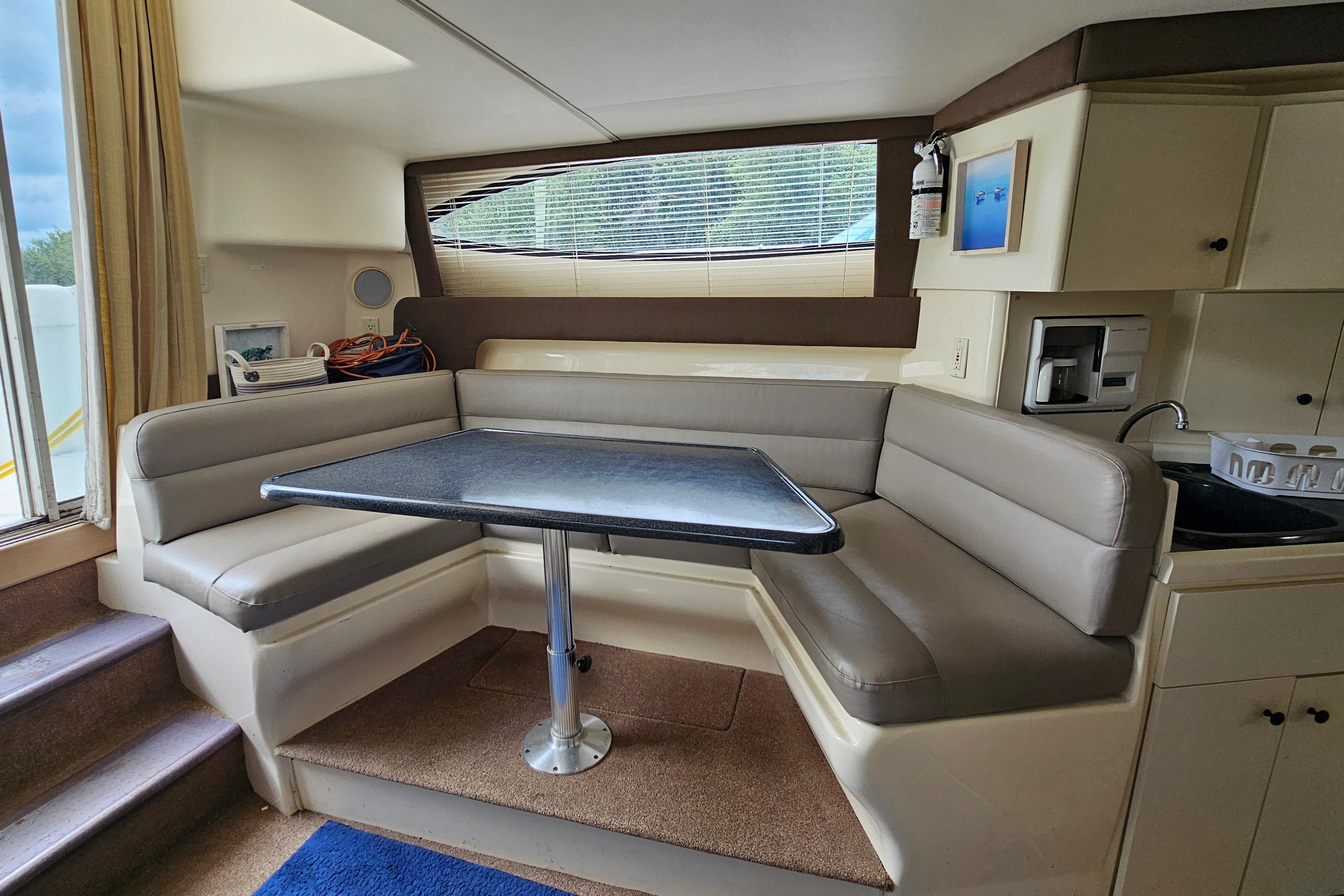 Interior of 1999 Carver 350 Mariner yacht with cozy seating and dining area.