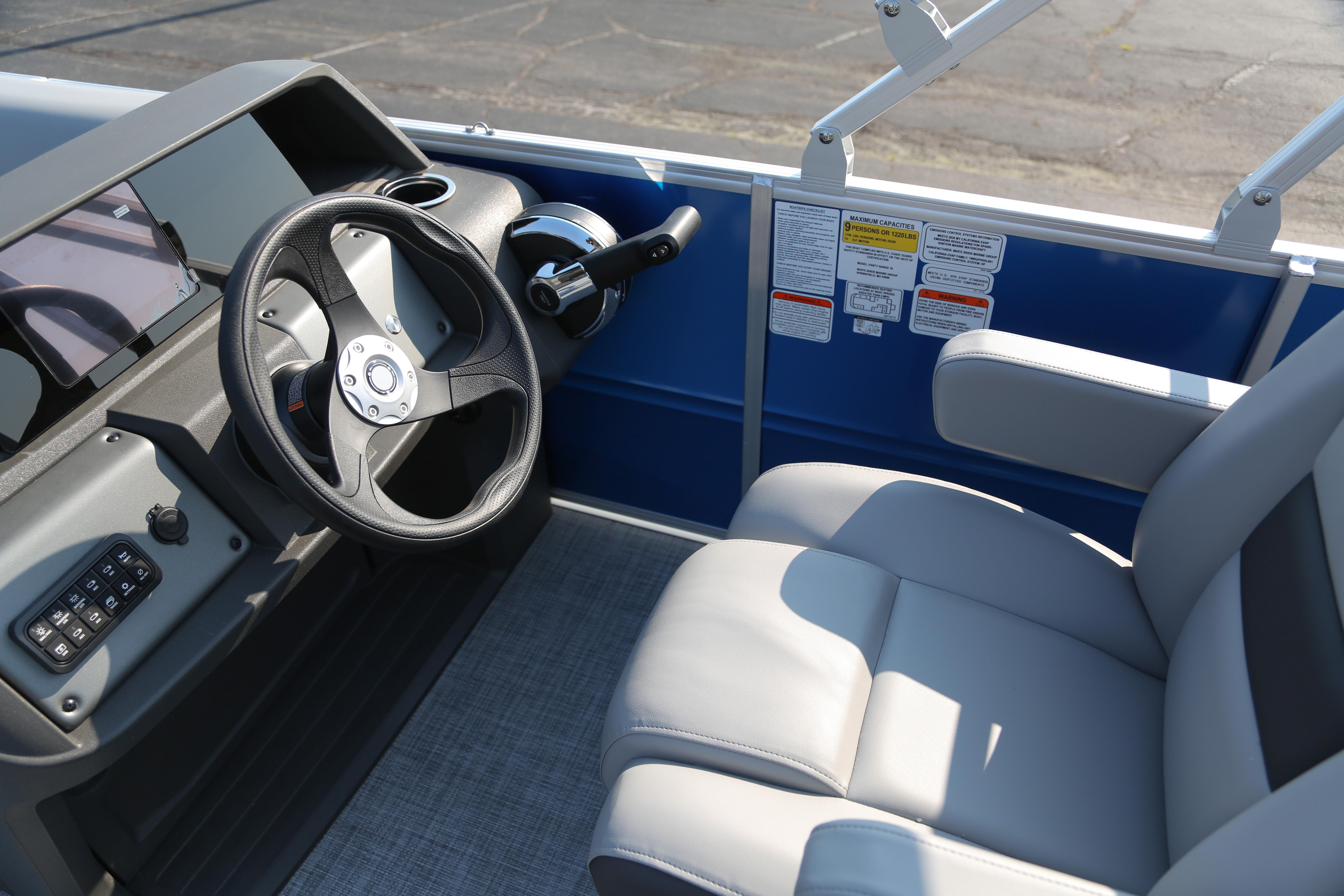 2026 Sun Tracker Party Barge 18 DLX interior with steering wheel and seating.