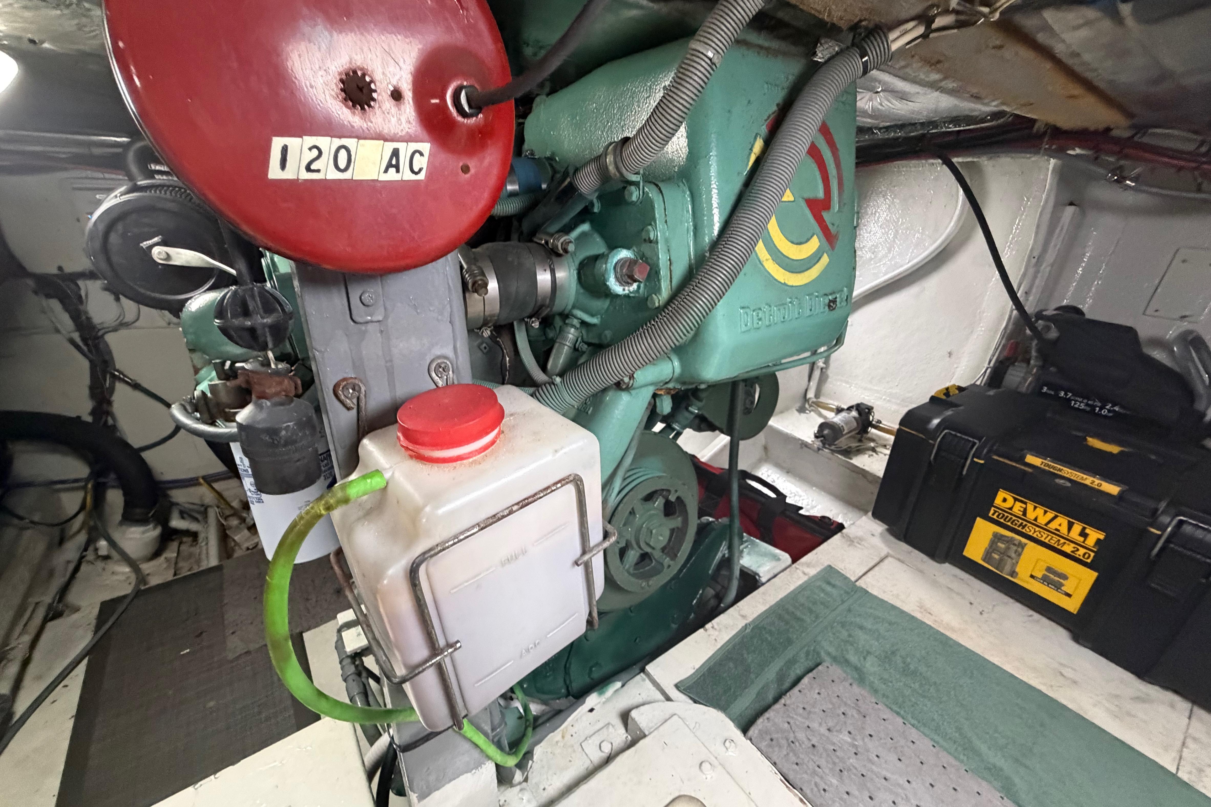 Engine room of a 1986 Bertram 46 Convertible with visible machinery and tools.