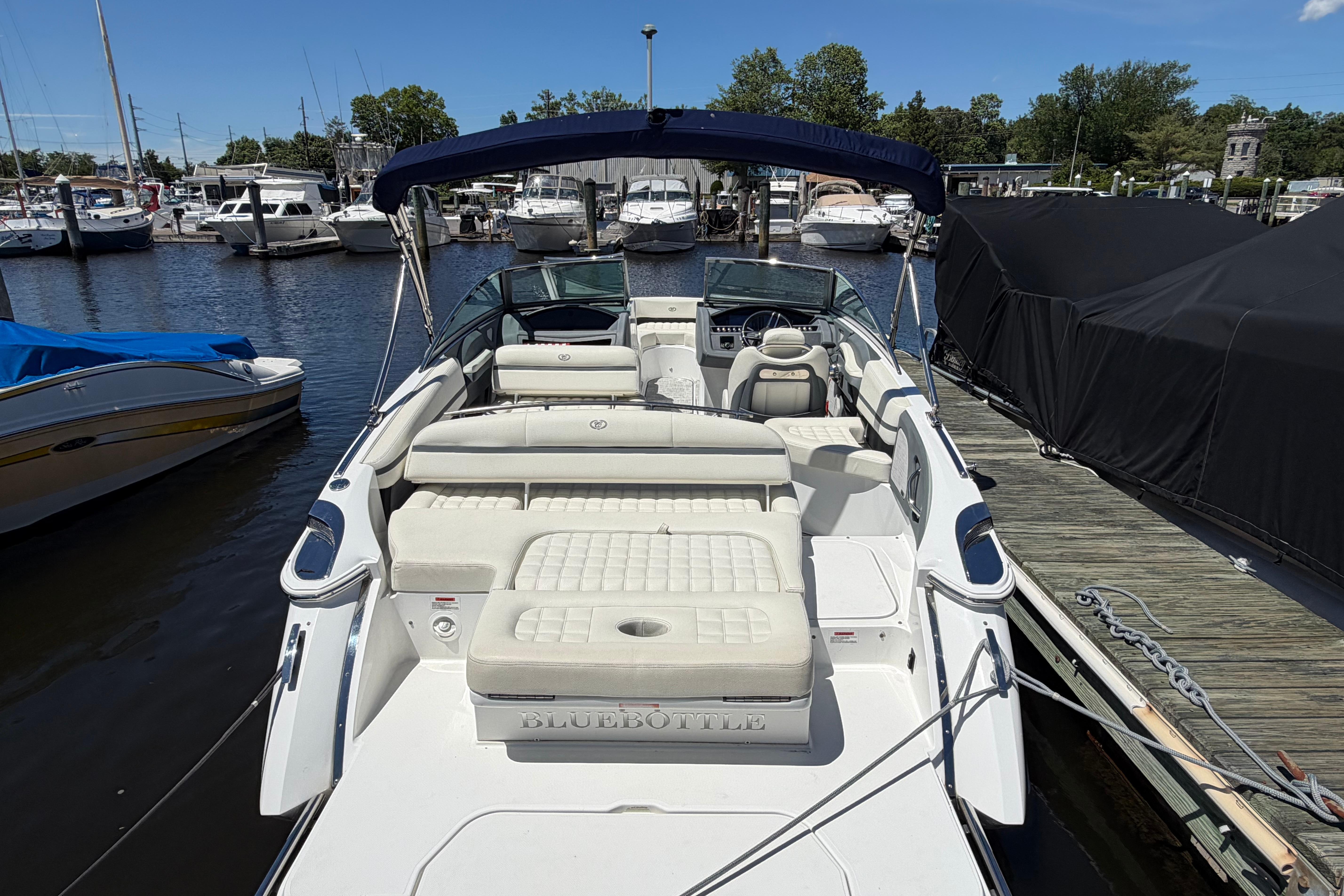 2020 Cobalt R3 boat docked at marina with spacious seating and canopy.