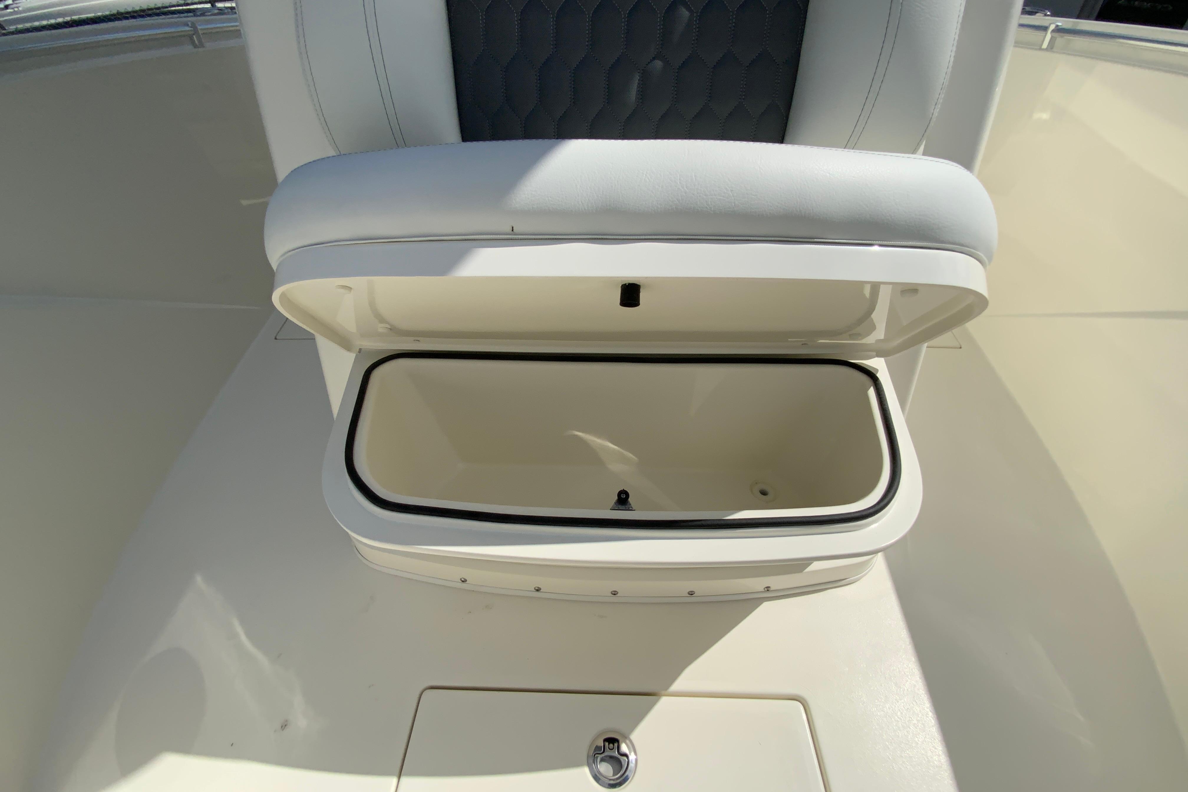 Open storage compartment on 2027 Cobia 320 Center Console boat.