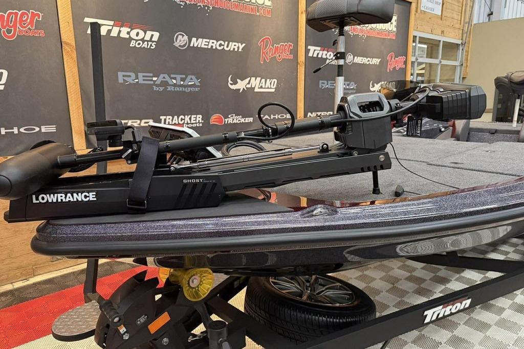 2026 Triton 20XP Patriot boat with Lowrance Ghost trolling motor on display.