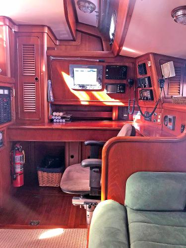 Interior of a 1988 Little Harbor 53 with wooden furnishings and navigation equipment.